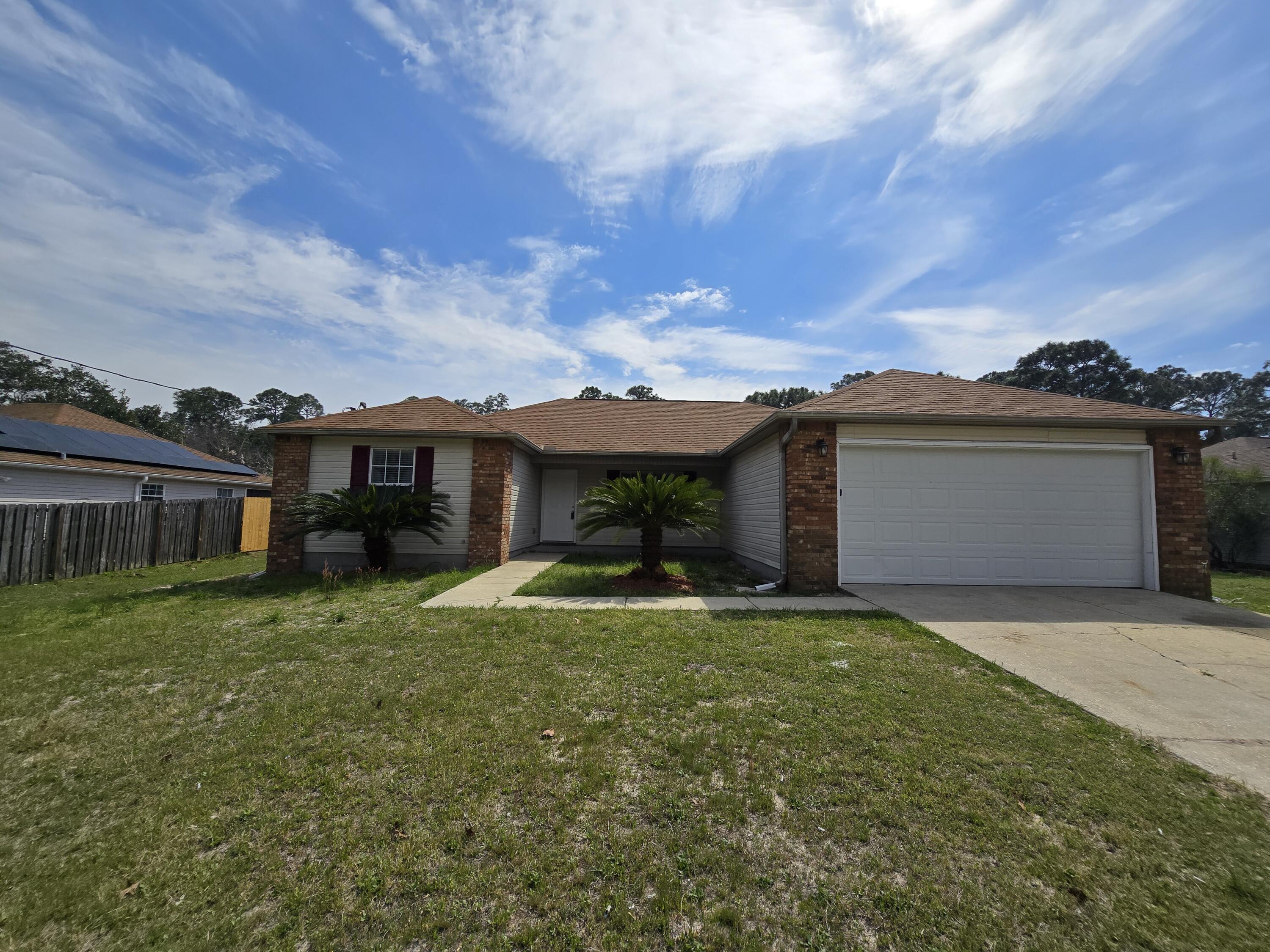 'REO' Come take a look at this 4 bedroom, 2 bath, split bedroom, open floor plan home! The kitchen features stainless steel appliances, a pantry, granite countertops and breakfast bar. The living area is open with cathedral ceilings. Access the very nice screened Florida room from the living/dining area. Plenty of room on 3/4 of an acre with a completely private fenced backyard. Location is everything! Beautiful Navarre Beach, public boat ramp, schools, restaurants, shopping and many new businesses are just a short drive, less than 10 minutes!