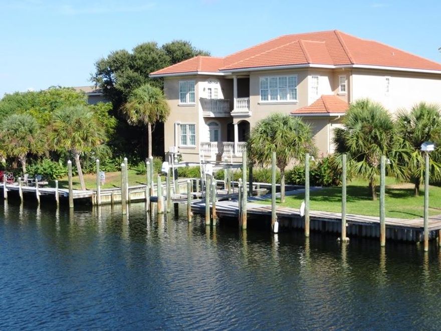 Romance! And fun times! This luxurious 2006 open and spacious 4500 sq.ft. 5-bedroom / 5-bath home with 3-car garage has places for 4 boats, including 2 upland slips (one with a lift and one not). Waterfront, east to west: alongside dock 14'9'', upland slip with lift 12' width 50' OAL, upland slip 16'8'' width 50' OAL, alongside dock 38'6''. Draft: The Destin Harbor canals are maintained at 6 feet. Large sheltered rear terrace. A spot for a pool if you deem. And Vera Cruz Drive is the first street off the beach, where you have platted neighborhood beach access and stop signs stopping traffic for you and yours to cross the street there. Fabulous big well-appointed and well-equipped kitchen, open to den. Wall of windows in den looks to the waterfront. Elevator shaft. Come see this house.