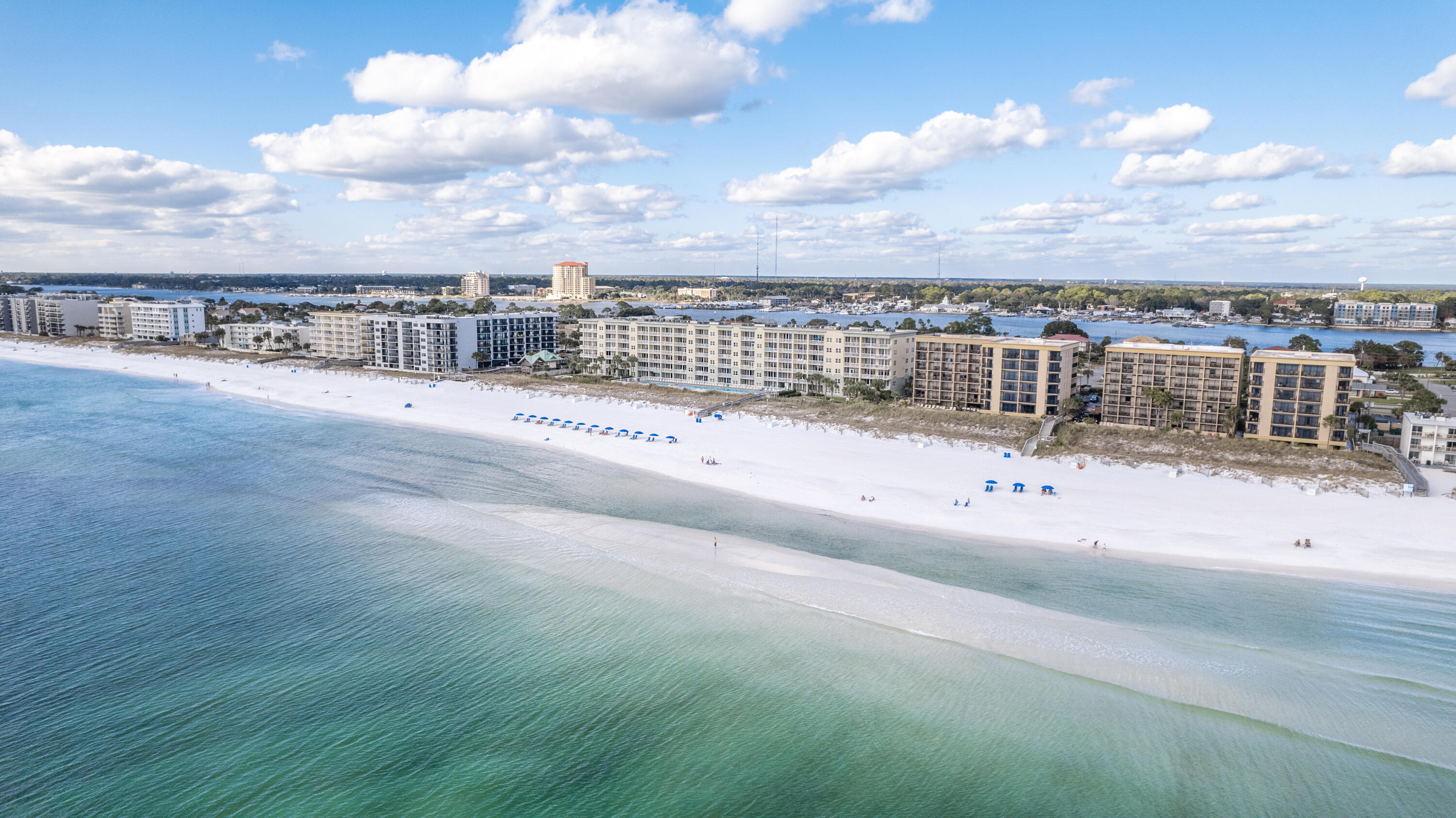 This fourth-floor unit at Waters Edge offers stunning panoramic Gulf views! The combined main living area, dining room, and kitchen all feature breathtaking views through large glass sliders. Granite countertops and updated stainless steel appliances give the kitchen a clean look. The spacious balcony allows you to take in the views and sea breeze from sunrise to sunset. The master suite is located in the north end of the unit and there are hallway bunks. With two full bathrooms, island-influenced style and decor, easy-to-maintain tile flooring throughout, and a desirable location this unit makes a fantastic rental property! Waters Edge is a desirable Gulf-front community with fabulous amenities including two Gulf-front pools, a beachfront gazebo, grilling and picnic area, parking garage,