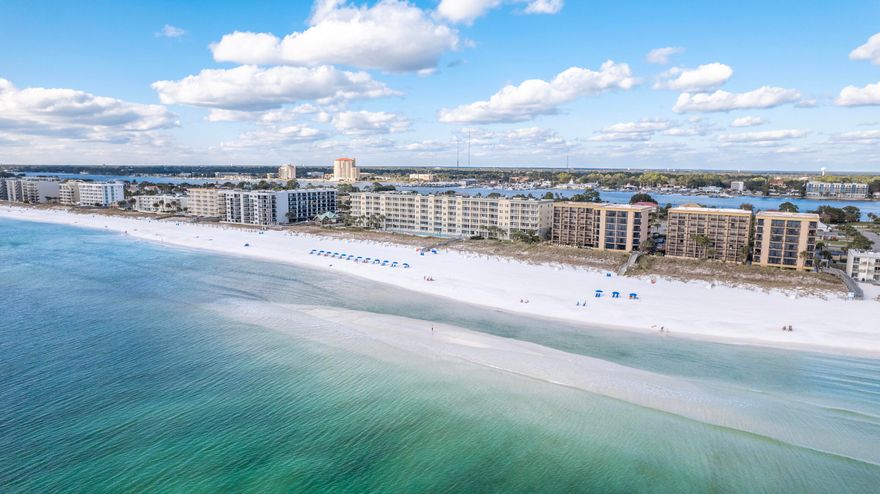 This fourth-floor unit at Waters Edge offers stunning panoramic Gulf views! The combined main living area, dining room, and kitchen all feature breathtaking views through large glass sliders. Granite countertops and updated stainless steel appliances give the kitchen a clean look. The spacious balcony allows you to take in the views and sea breeze from sunrise to sunset. The master suite is located in the north end of the unit and there are hallway bunks. With two full bathrooms, island-influenced style and décor, easy-to-maintain tile flooring throughout, and a desirable location this unit makes a fantastic rental property! Waters Edge is a desirable Gulf-front community with fabulous amenities including two Gulf-front pools, a beachfront gazebo, grilling and picnic area, parking garage, fitness center, and a boardwalk to the beautiful beachfront with showers to rinse off after a full day at the beach. Paradise!