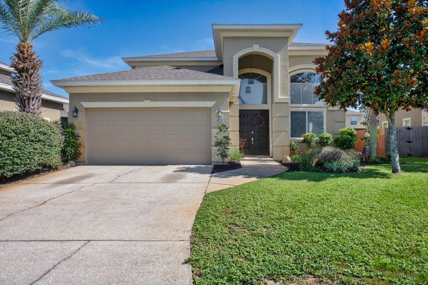 Back on Market to no fault of seller! Welcome to your Mediterranean dream home--where grand meets cozy and convenience meets style!Tucked away in the beautiful community of Solimar, this spacious 5-bedroom, 2.5-bathroom home offers the perfect blend of elegance and everyday comfort. Just minutes from Hurlburt Field, yet nestled in a quiet and private corner of Mary Esther, you'll feel worlds away without sacrificing location.Step inside to soaring 20-foot ceilings, freshly painted Milano cabinets, and stunning built-in bookcases that add charm and functionality to the airy living room. The large dining area is ideal for entertaining and includes a sleek butler's cabinet with wine fridge for extra storage and serving space. On the main level, the owner's suite is your own private retreat, complete with two walk-in custom closets, a soaking tub, and an oversized walk-in shower that'll make every day feel like spa day.
Upstairs, you'll find four more spacious bedrooms, perfect for family, guests, or a home office or two. Outside, your gunite pool with water feature brings the vacation vibes home, just add sunscreen and your favorite float. (Buyer to verify any information that is important to them).
