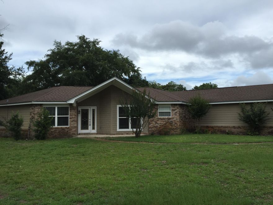 What a lovely home that is open and airy. It has beautiful hardwood floors throughout. Unique brick floors in the kitchen with granite counter tops and stainless steel appliances complete with a gas-cook top stove. The living area has a wood burning fireplace. The home has a split floor plan with the master bedroom on one side along with a 4th room that could be used for an office, and the other 2 bedrooms on the opposite side. Nice big pantry/laundry room off from the kitchen area. The nice big garage has lots of cabinets and storage areas. There is a boat ramp just down the street for public use which makes this an ideal area for the water lover. The back doors are in the process of being replaced. The sprinkler system with well pump convey as-is.