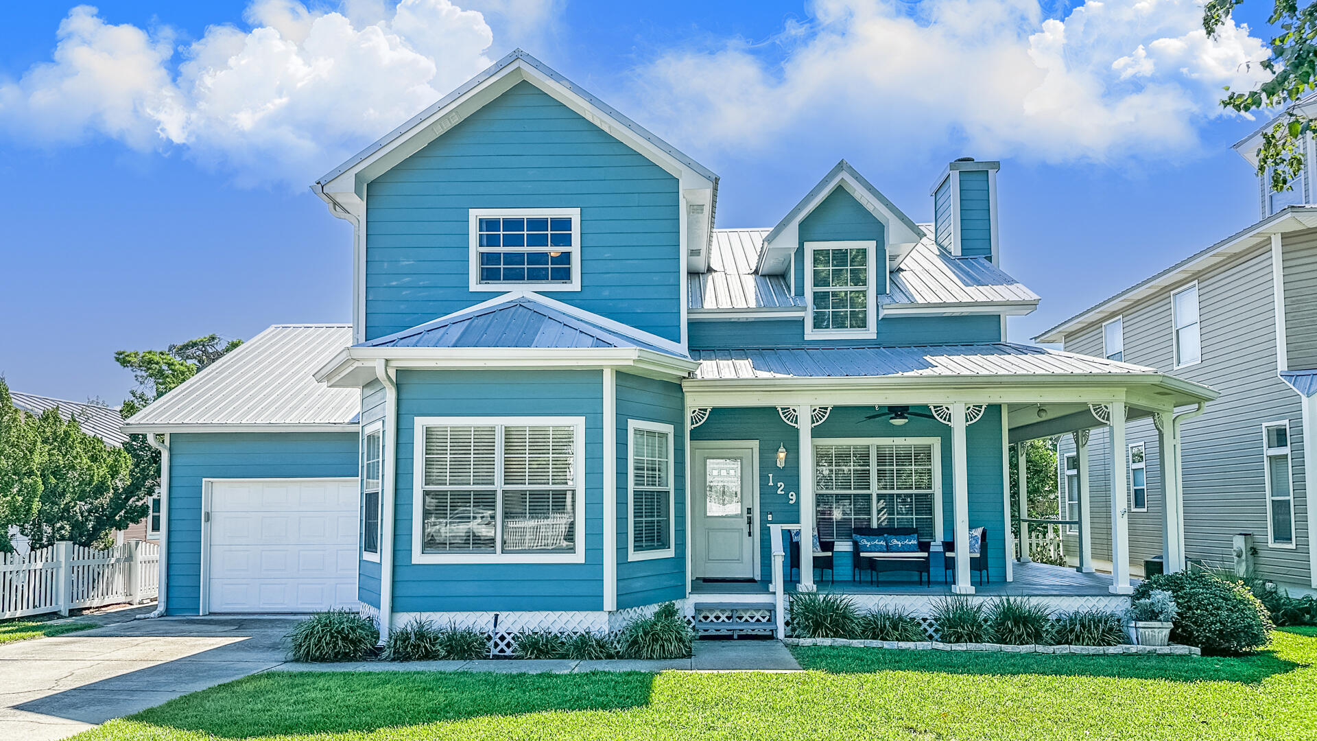Welcome home to this beautiful 2 Story house that LOOKS and feels newer because of all the updates. Home is located on the quiet Bid a Wee Lane ,in the coveted PCB beach community with a short walk to Bid-a- Wee Dedicated Beach with Private Locked Access Gates . With 4 Bedrooms and 3 Full Baths make this a perfect Family Home, Primary Home or Second Home .The Kitchen has been updated with stainless appliances, tile backsplash ,nice pantry and kitchen island for all your prep work.2 new doors off the kitchen that really bring in natural light . Upstairs ( check out the stairs and wallpaper and custom woodwork) you will find a Master Bedroom with 2 walk-in master closets and an ensuite bathroom remodeled with soaker tub and tiled shower. The Guest Bedroom upstairs is also an ensuite with a with a updated bathroom, walk-in closet and nook storage area. Head back downstairs to the Big Family Room that is perfect for all your entertaining and includes a working Fireplace equipped with electric logs/heater for those cool nights .Adjacent Big Bedroom that is currently being used as an office and work out room is a must see for it's multi-use possibilities .This space includes new frosted glass doors added to the spacious closet. 4th Bedroom with Full Bath and washer/dryer are conveniently located off the kitchen. Other key features of this ideal family dream home include : all closets are freshly painted; wood floors in Family Room ; LVP in all bedrooms; tile in baths ,kitchen and dining area ; hardi- plank siding; metal roof ;wrap- around front/side porch(freshly painted );all electric; patio out back ;large back yard for kids/pets with space to add a pool if desired ;and an oversized garage with storage room .