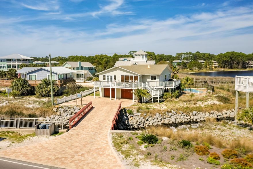 Amazing investment property with $161,418 in proven rental history. This beautiful beach house is one house off the beach and sits on Oyster Lake.  Oyster Lake is a rare coastal dune lake.  Coastal dune lakes only occur in a few places around the world. The home has been completely remodeled with new porcelain tile flooring throughout, new kitchen, new high-end Whirlpool stainless steel kitchen appliances, granite counter tops, large luxury pool with play shelf, water features, 8 ft Jacuzzi and Travertine tile 'natural stone' pool deck, new wooden garage doors, beautiful new paver driveway and a huge wrap-around 'Ipe' (Brazilian Hardwood) deck. The is in within walking distance to the Santa Rosa Golf Course, Topsail Hill Preserve State Park and has a private heated pool .