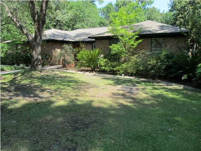 ''Life is Goodon the Bayou''. Enjoy privacy and tranquility in this luxurious brick home close to everything, but far enough from the stress of clogged roadways and traffic. Home was remodeled in 2007 with many upgrades. Island in kitchen with stainless steel appliances, fireplace in living room, large walk in closet in master bedroom. Both bathrooms have been completely remodeled. The master bathroom has a jacuzzi tub with separate tiled shower with double shower heads, bidet, and a double vanity. The back yard is fenced and has room to park an RV, boat or plant a garden. 21' x 16' screened Florida room. Landscaping is low maintenance with an automatic 6 zone sprinkler system on a fresh water well. Community dock and water access to the Bayou. Boat marina and a Sport Center is under