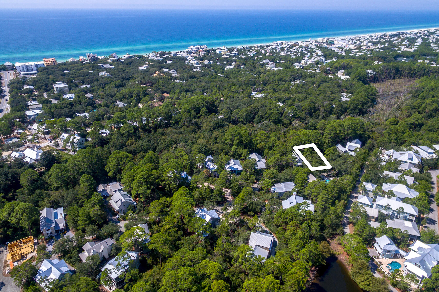 Gorgeous lot in the heart of Seagrove.  The Hammocks is a gated neighborhood, offering 2 community pools, abundant natural landscaping and a most desirable location.  This homesite is towards the end of Hammock Lane offering the utmost of privacy.  The back of the lot borders green space which leads to a canal that feeds into Western Lake.  The neighborhood is well established, low HOA dues and no build out requirement.