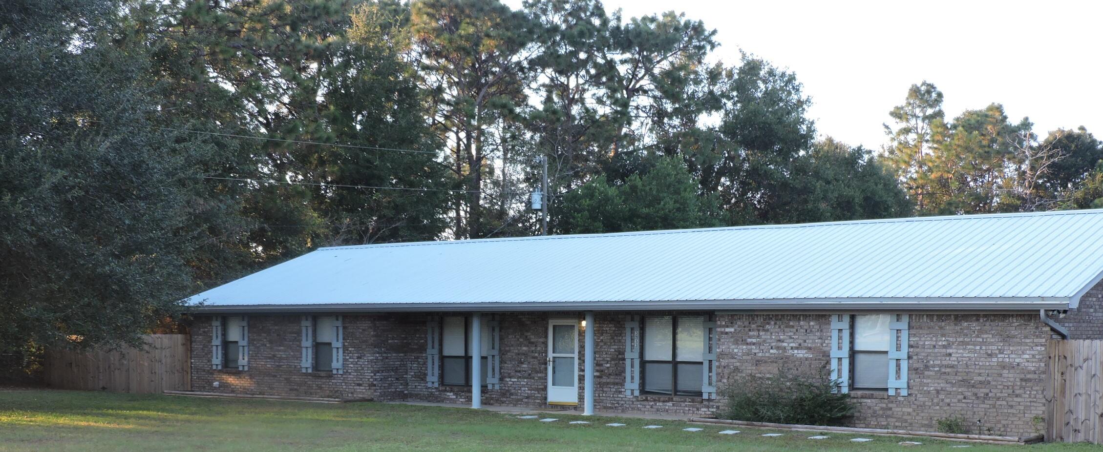 Completely updated in 2020! This all brick spacious 4bd/3ba 2700sqft home comes equipped with a 20 KW propane generator that automatically starts when the power goes off. This home has a 5th room that can be used as office and a nice 24x24 Florida room that is not figured in the total square footage of home. Metal roof 6yrs old. 24x16 workshop out back, which has water and electricity. Master suite has extremely large walk-in closet, garden tub in bath. Custom shelves/drawers in bedrooms. Open floor plan, has wood burning insert fireplace with electric blower. Kitchen appliances just over a year old. Seller is offering 1yr home warranty up to $600 and $1500 towards carpet replacement. Has sprinkler system and Cox security system. Privacy fencing. Wheelchair accessible.