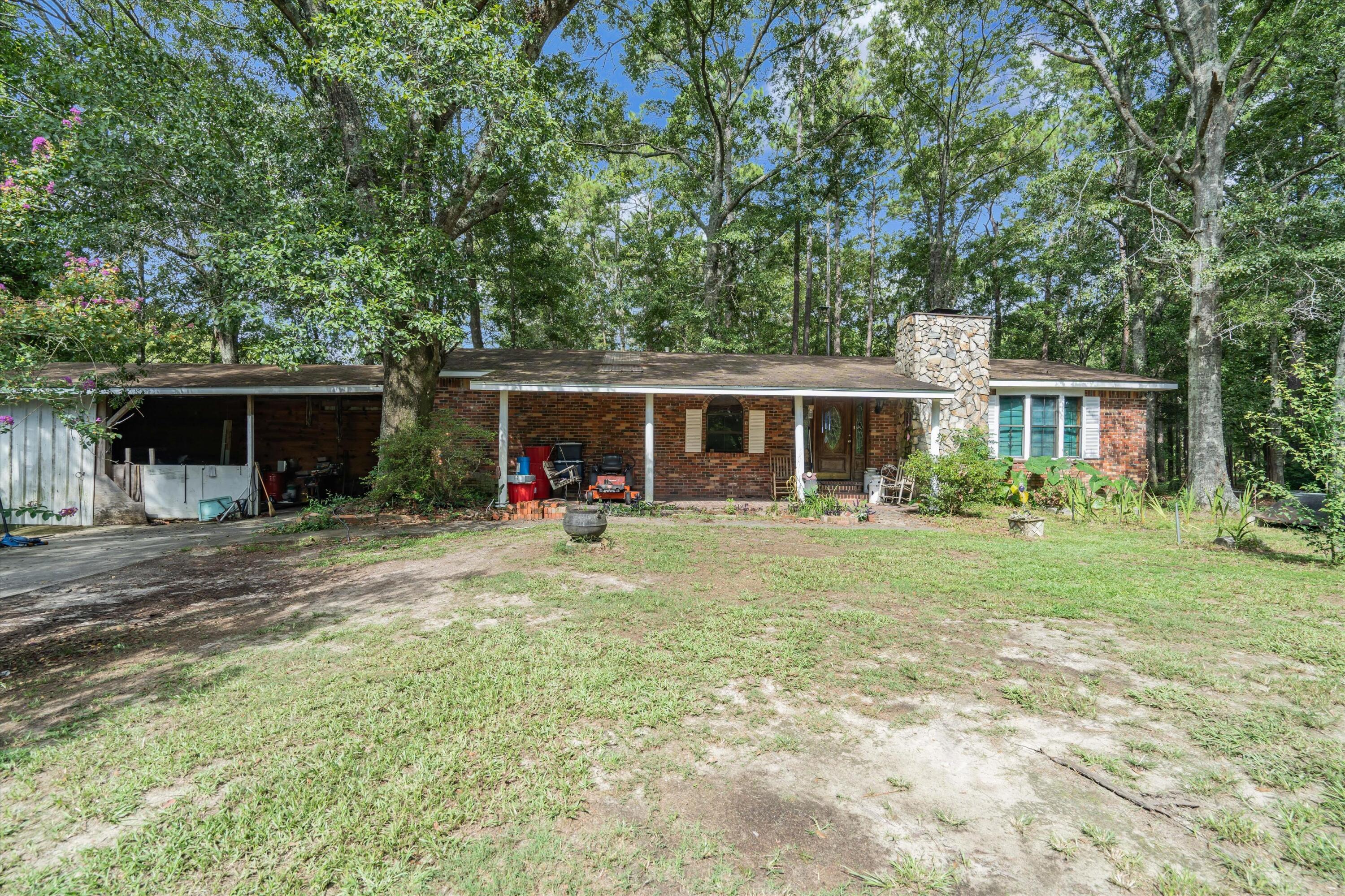 Experience charming country living with this beautiful brick home nestled on 5.7 acres of picturesque land. Whether you're looking for a primary residence or a serene getaway, this custom-built three-bedroom, one-and-a-half-bath home offers a unique blend of comfort and natural beauty. KEY FEATURES: Location: Situated on 5.7-acres with breathtaking views of trees, a pond, and deer roaming the property. Interior: The home's interior features premium cedar lining on all walls and most ceilings. If cedar isn't your style, consider painting it white for a stunning shiplap look. Fireplace: Enjoy cozy evenings by the wood-burning fireplace. Dining: Formal dining room for family gatherings and special occasions. New HVAC System.(Continued) Kitchen: Country-style kitchen with ample space for culinary creativity. Sunroom: Relax in the sunroom, which offers additional living space not included in the square footage. A small pond on the property offers relaxation for fishing enthusiasts. Valuable timber on the property adds to its allure and potential value. ADDITIONAL AMENITIES: Workshop: A workshop and an additional out-building provide versatile spaces for hobbies, storage, or other uses. Flooring: Carpet will need replacing. Some work needed. This property is a rare find, combining the charm of a country home with modern conveniences and abundant natural beauty on 5.7 acres. Don't miss the opportunity to make this charming retreat your own!