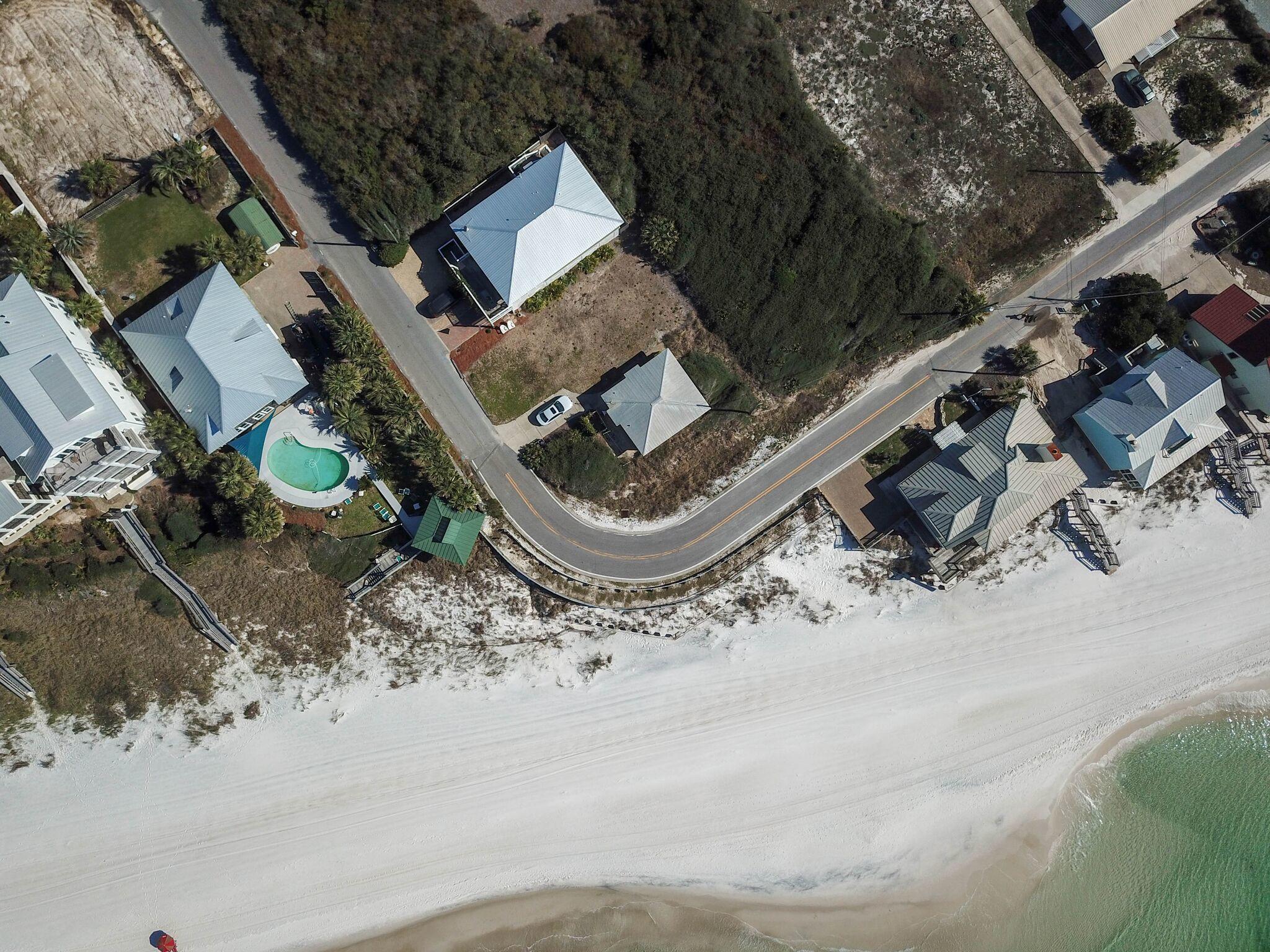 Unarguably the best, most unique lot in Inlet beach, and possibly all of 30A. The land, and existing two bedroom old Florida cottage have been family owned since 1952. This property holds a families heart felt life of dreams, and memories of the beach. It now can be yours! This corner lot affords the opportunity to enjoy endless Western views of sun, sand, and water. No one will ever build in front of you. It sits on a gentle turn in the road, a step back in time. Equidistantly located between two beach boardwalks, and a short walk to all that Rosemary has to offer!A must see! Learn the history of ''The Hans Cliff House'', and make it your own. Survey is available upon request! Please click on the video link and enjoy!
