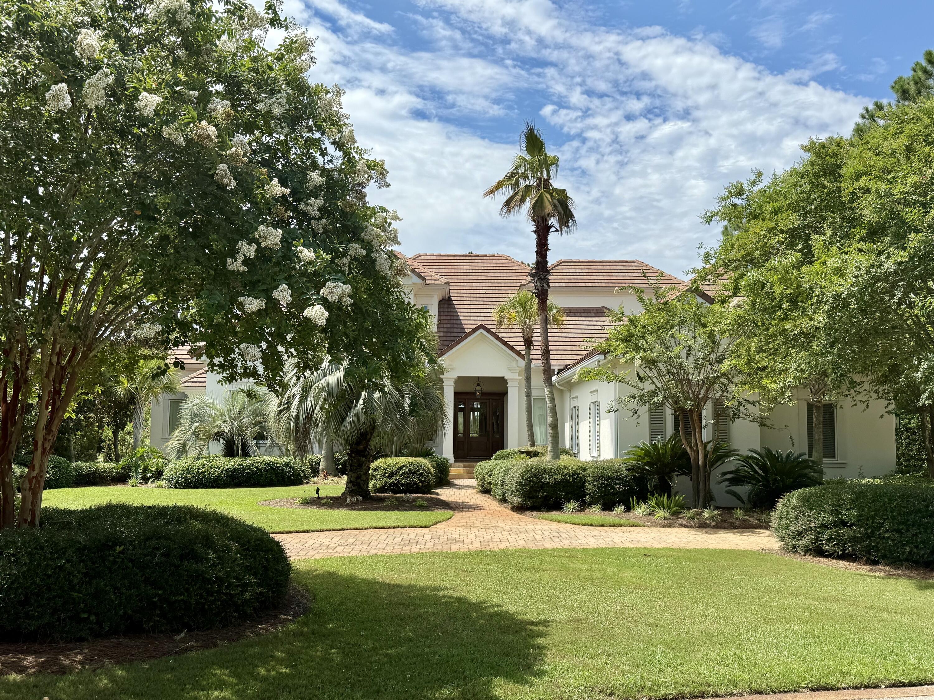 Don't miss a wonderful opportunity to own this custom 4,626 square foot residence located on one of the most desired streets in the prestigious, gated community of Burnt Pine, situated within the exclusive Sandestin Golf and Beach Resort. This exceptional 4 bedroom, 6 bath home exhibits timeless design and overlooks the 16th green - boasting expansive golf and water views and an incomparable, picturesque setting surrounded by mature trees and lush, manicured landscaping. The classic interior features 12 foot ceilings downstairs, 10 foot ceilings upstairs, custom cabinetry, extensive moulding, woodwork, natural stone and hardwood flooring, and luxury finishes to complement varied decor. Home details... The first level offers a spacious & flexible floor plan with living areas open to the kitchen and dining spaces to keep gatherings connected. The gourmet kitchen is a chef's and entertainer's dream featuring an oversized quartz island with hidden storage, professional-grade stainless appliances, including 3 ovens, a warming drawer, custom cabinetry with pull-outs & generous storage, plus built-in wine & bar areas.
Living spaces are drenched with natural light from abundant windows and French doors that showcase a stunning vista that never gets old. Three sets of French doors open to a lovely back porch with remote retractable screens, an outdoor kitchen, gas fireplace, and enough room for dining and relaxation. Open the automatic screens and step out to your private tropical paradise featuring a unique pool design with programmable heater, light, and water features, twin fire bowls, sun shelf & loungers, and hot tub where you will enjoy the nearby bay breezes, night sky and Baytowne Wharf fireworks from the perfect distance.
The first floor includes a sprawling master suite complimented by a sitting area with French doors that open to the back porch. Large, his & her walk-in closets include built-in wardrobe storage. Spacious bath features an expansive walk-in shower, garden tub, palatial mirrors, quartz, and mother-of-pearl finishes.
Also on the first level is an office suite with custom built-in desk and cabinetry and a half bath, as well as laundry room with built-in cabinetry & counters, and a second half-bath. Additionally, storage closets, a walk-in pantry, and central vacuum system make for a user-friendly and well-maintained home.
An impressive stairwell leads to the second floor which contains 3 bedrooms, each with en suite baths that include a walk-in shower. Two of the bedroom suites have French doors that open to an upper porch overlooking the delightful pool area and panoramic view. All bedroom suites include ample closets with built-in storage.
The large, 3-bay garage accommodates 2 vehicles, plus 1-2 golf carts, water toys, bikes, and more. Garage features epoxied floors, work areas with built-in cabinetry & utility sink, an additional storage closet, and an upstairs attic space which can be used for extra storage or a potential finished bonus area if desired.
As a private, gated community, Burnt Pine residents appreciate the added benefits of security and seclusion within Sandestin resort. Additionally, Burnt Pine spotlights a breathtaking, private golf course with a coveted, newly renovated clubhouse with amenities.
Sandestin Golf and Beach Resort offers an exciting lifestyle experience in a truly remarkable outdoor setting situated between beautiful Choctawhatchee Bay and the flawless white sand beaches of the Emerald Coast. This one-of-a-kind resort features 2,400 acres offering: 4 championship golf courses; world-class tennis courts; pickleball courts; a state-of-the-art fitness center and spa; renowned beach with watersports; pools; annual club membership options including the chic, newly updated Beach Club, Burnt Pine Club, Golf Club, Tennis Club, and Fitness Club; a full-service, 223-slip marina; nature & biking trails; stocked lakes for fishing; sidewalks & golf cart paths; and an array of restaurants, boutiques, galleries, entertainment venues with scheduled weekly events, nightlife options, and more. For more detailed information on Sandestin Golf and Beach Resort, visit their website at www.sandestin.com.