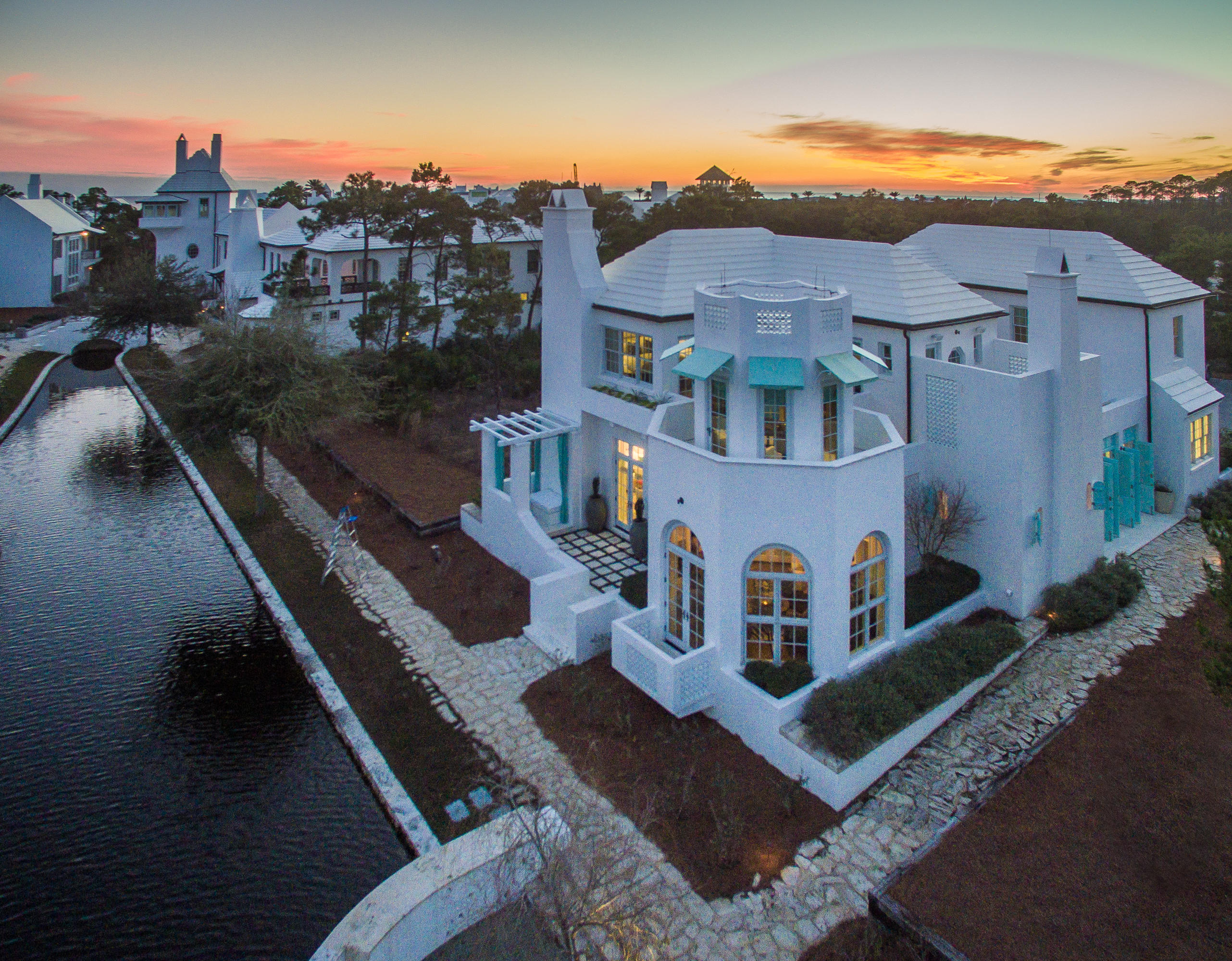 Beach Bohemian Chic comes to Aly Beach with Architect, Gary Justiss and Alys Beach Construction. This 5,271 sq ft courtyard home overlooking Lake Marilyn has recently undergone a complete transformation with luxurious rugs, lighting, mirrors, finishes and interior appointments. Highlights include octagon rooms, 100 year old barn beams, private heated/saltwater pool and fountain, Poolside arbor with Grille Terrace, covered dining for 8, fireplace with built-in seating Loggia and a Basement with Multi-use space: four bunk beds with lounge area & TV, full bath, secondary sectional seating area with projection screen TV, bar with Electrolux refrigerator and wine room. All furnishings are offered with this home.