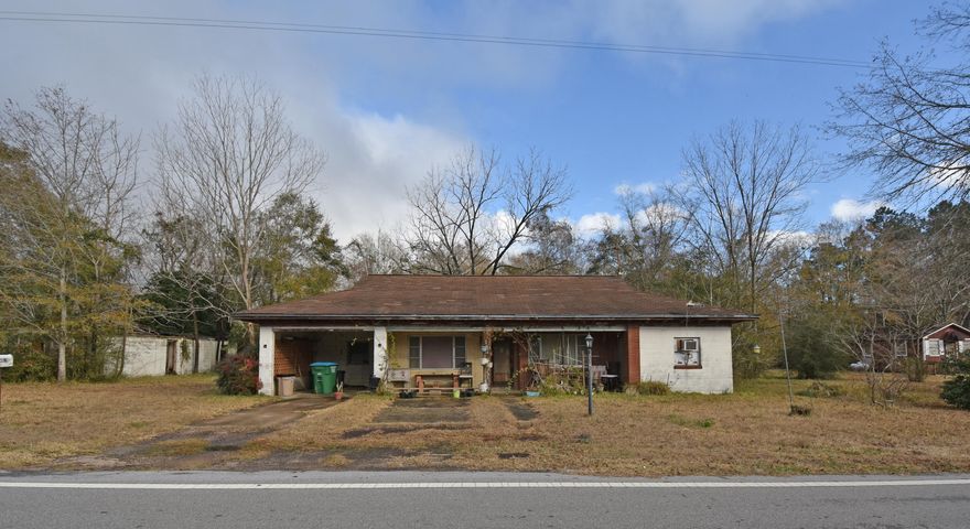 If you are looking for property that has the utilities in place, take a look here. Handyman special!!! This home needs a lot of work so you can decide to restore it or choose to take it down. Concrete block construction. There is also a block shop on the property that could be restored. Large lot with 4 - 50 x 190 ft lots for .87 acres of land. Located right across from Laurel Hill School. Be sure to take a look!