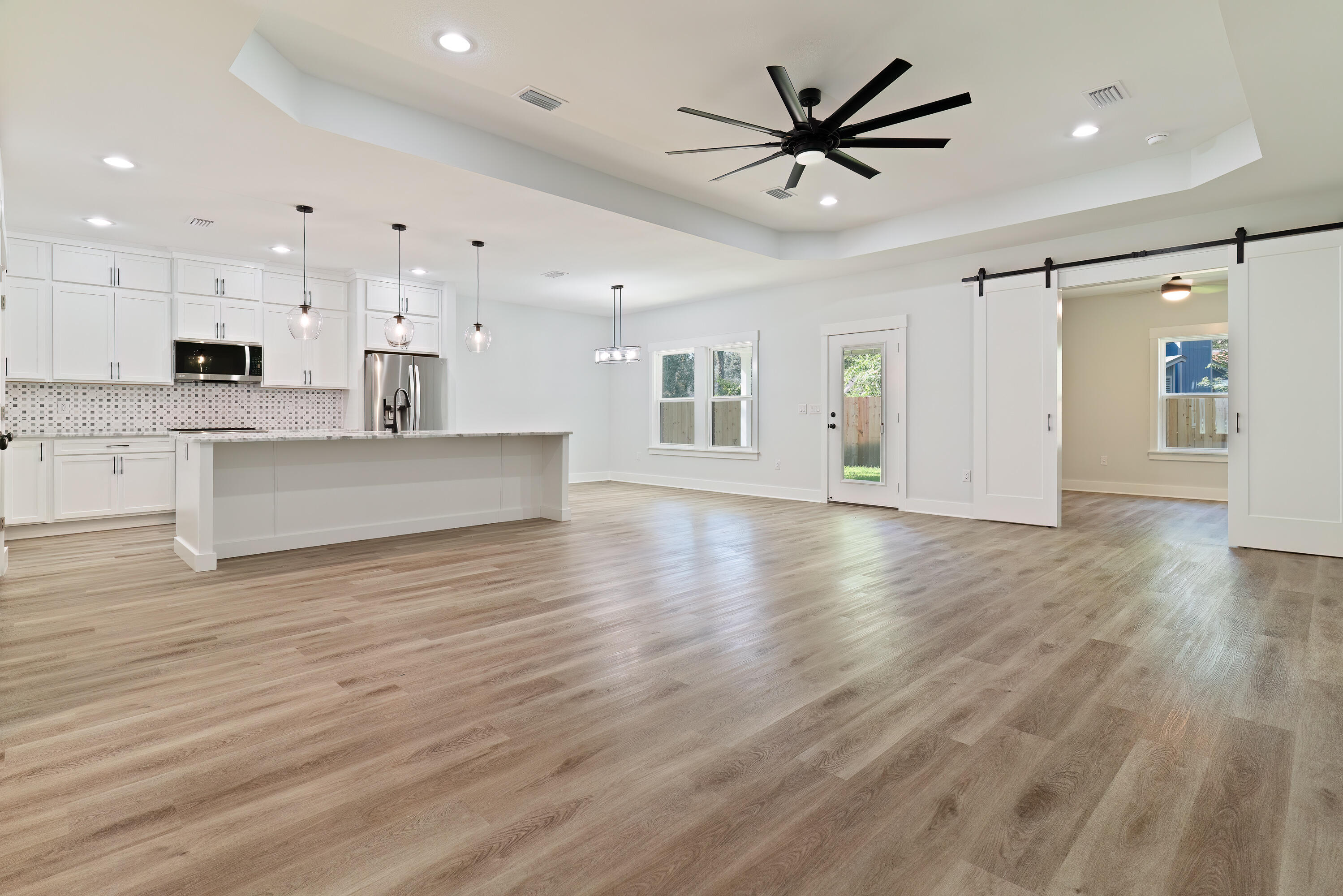 $15,000 ANYWAY MONEY towards closing costs or Interest Rate Buydown. New Construction 5 Bedroom home with Hardie Board Siding on Front with Brick on the rest. As you enter this open floor plan home luxury vinyl plank invites you into the foyer & carries throughout. On either side of the foyer are 2 bedrooms & 1 bath. As you continue in the living room opens to your dining area & kitchen with large island. White cabinets & matte black hardware provide a classically modern vibe. Grey & white marble counters complete the look. Sliding doors from the living room open to a sitting area off the primary suite. The sitting area is a great office, reading room or nursery. Primary bath has a tiled shower, separate tub, double vanity & walk-in closet. Privately fenced yard with room for a pool.