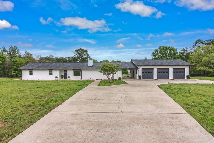 This property is THE ONE! This stunning 3/2 is full of upgrades that will surely check all of your boxes! This home is sitting on nearly three acres of land and backs up to TWO stocked lakes! This home features an open floorplan with an oversized livingroom that boasts a stunning wood burning fireplace and kitchen that is a chefs dream! There is an additional living area when you enter in from the carport that is perfect for entertaining! Head to the back sunroom and you are going to enjoy the showstopping views of the pool, lakes, and breathtaking scenery. This home offers a massive three car garage with workshop and a 30 amp RV hookup. Schedule your showing today!