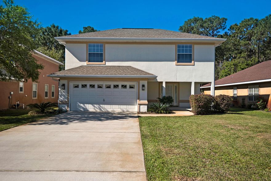 A well maintained two story residence with a covered front porch featuring over 2300 square feet of an open and bright floor plan. The large foyer leads to the spacious living/dining room with two story ceilings boasting a double row of windows. The breakfast bar separates the kitchen from the dining area and features stainless appliances and Corian countertops. The first floor Master Suite offers a tray ceiling, walk-in closet, double vanities, separate shower and whirlpool tub. The other two bedrooms are upstairs along with an open loft perfect for a play space, office or another sitting area. This home features rain gutters, backs up to the Driftwood Estates conservation area and is a short distance to the county maintained park and community pool.