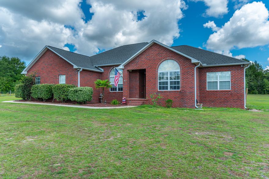 Beautiful custom built brick home, country living, and almost 5 Acres of land. Convenient to I-10, the bases, and Baker schools. Enjoy the privacy of the large Master Suite with this split floorplan design home. High ceilings make the 2,420 square ft living area seem even larger. If you want to be inside and still enjoy the view of the outdoors take advantage of the large tiled Florida room on the back of the home. This home has a beautiful office area for the kids homework or if Mom or Dad work from home.  Outside there is a detached building/workshop for lawn machinery or the handyman of the house. Enjoy the outdoors even more with deeded access to the private lake at the end of your road for fishing, hiking or just enjoying nature. To much to list here !!! Call your agent today !!!