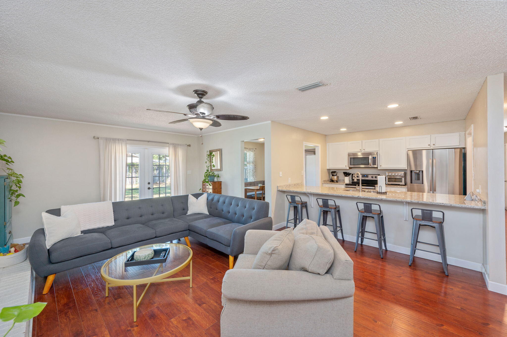 Beautifully updated home in the heart of Niceville! Enjoy an open kitchen with granite counters, modern white cabinets, stainless steel appliances, and a breakfast bar overlooking the living area. Natural light fills the space with wood laminate flooring in all the main spaces and a neutral palette throughout. Home features both a formal living room and a cozy den with a white brick fireplace--perfect for gatherings. A formal dining room to finish off the main areas. Bedrooms boast ceiling fans and plenty of closet space. Spacious, level fenced yard with patio for outdoor grilling. Two-car garage adds convenience. Major updates include a new roof before closing and recently replaced AC and water heater--truly move-in ready!