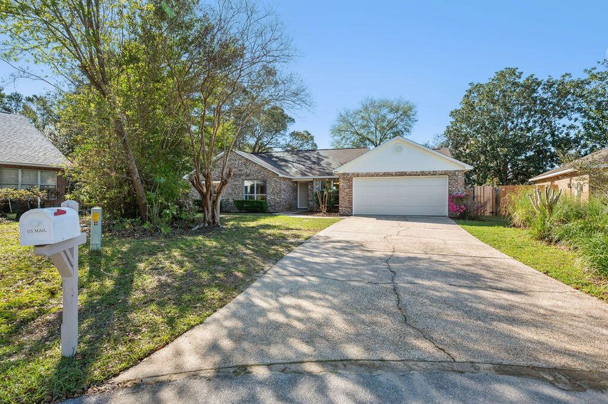 Tucked away at the end of a quiet cul-de-sac in the gated community of Parkwood Estates, this beautifully refreshed home blends privacy, space, and thoughtful modern updates.  Situated on one of the largest and most desirable lots in the neighborhood, the property backs to mature trees and is adjacent to Eglin Reservation, creating a peaceful, natural backdrop rarely found in Bluewater Bay.  Inside, the home has been thoughtfully refreshed with a bright, clean, modern aesthetic.  New vinyl plank flooring flows throughout, complemented by freshly painted interiors and ceilings, new updated baseboards, modernized electrical outlets and switch plates, and all-new window screens. The kitchen features professionally refinished cabinetry, stainless steel appliances, gas stove, bright breakfast nook with built-in desk and new French doors leading to the backyard, filling the space with natural light and offering an updated, energy-efficient design. Both bathrooms have been beautifully renovated. The spacious Master features 2 closets and offers a new vanity, new fixtures, and new shower with glass door.  The secondary bath offers a new vanity, new tub, and updated fixtures for a cohesive move-in-ready feel. Designed for comfortable living, the home includes 4 generously sized bedrooms including a 17x15 Master bedroom, two full baths, a spacious great room with gas-log fireplace, vaulted ceilings, a separate dining room, and an oversized utility room with cabinetry and workspace.  For added peace of mind, major systems have been addressed: Roof (2015), Water Heater (2019), and brand new HVAC (2025). Step outside to a tranquil patio and fenced backyard where mature trees frame the setting, creating privacy and a true sense of retreat. Walking distance to  Bluewater Bay Elementary School, this home is ideally located within the gated community of Parkwood Estates.  Enjoy convenient access to Eglin AFB, Duke Field, and Hurlbert Field, with Destin's beautiful beaches, dining, and shopping just a short drive away.  This is an exceptional opportunity in one of Niceville's most desirable gated communities.  