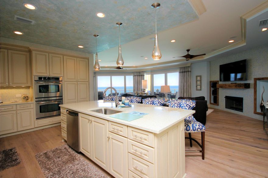 This stunning unit in Grand Dunes Resort is located in the grandest of all floorplans, the ''10'' stack of the South Tower. Providing a full 180 degree breathtaking view of the Gulf of Mexico. This gorgeous Lovelace Interiors designed unit is being sold furnished (excluding only a couple of pieces.) With 3,150 sq. ft. of interior living space, and 460 sq. ft. of covered, wrap around, tile clad outdoor living space. Adorned with a built-in stainless steel natural gas grill protected by hurricane shutters. Beautiful 9'' wide oak plank flooring, sea glass & shell countertops, custom cabinetry with soft close drawers, custom artwork, gas fireplace with custom pecky cypress mantle, surround sound with ceiling flush mount speakers, wet bar with matching countertop and cabinets, separate media