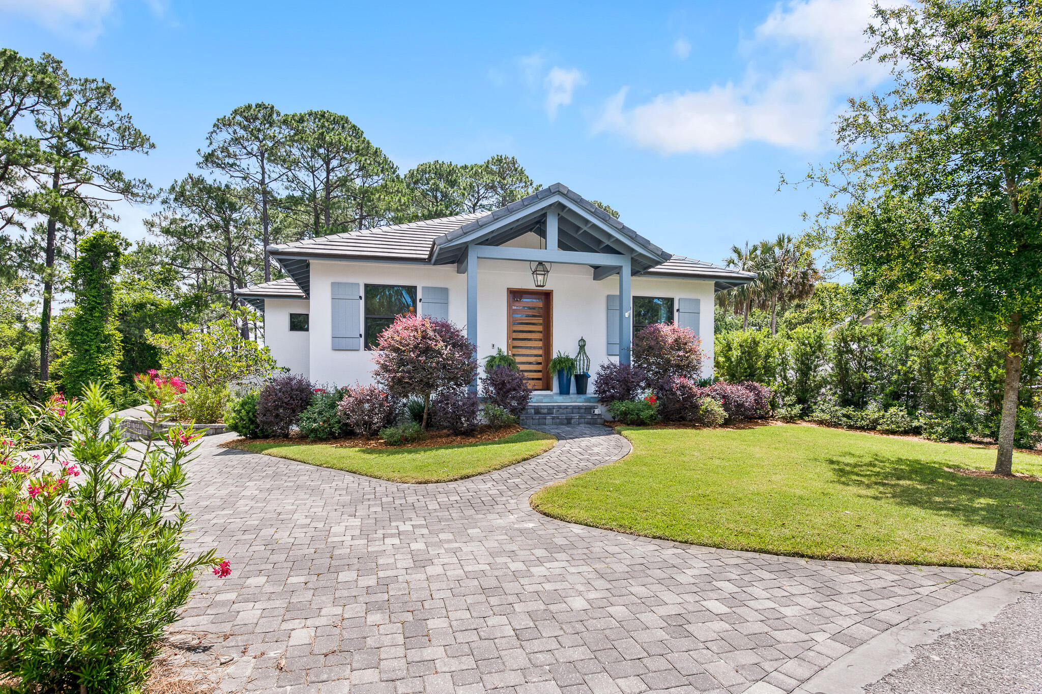 This custom home is the true definition of architectural elegance & beautiful spaces. Brick archways and modern coastal lighting really help this Dune Allen Beach property shine. Containing 4 bedroom + office and 4.5 bathrooms, the natural finishes and thoughtful details throughout the home are one of a kind: accent walls, high end appliances, custom molding and hardware, mosaic tiled tub, and exposed wood beams. Outdoor living is easy with fully retractable glass doors to the daybed swing, gas fire pit, and outdoor grill that overlooks large longleaf pine trees providing privacy and relaxation. The mature lot is spacious with room for a pool and deck area, with no HOA to guide your vision. Among this beautiful home's features are also: ICF structure (concrete), concrete tile roof, whole