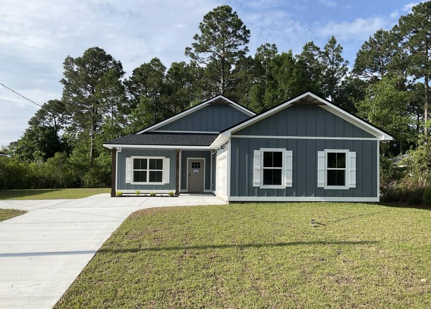 Newly completed and ready for move-in! NO HOA, 5 minutes to Navarre Beach! This semi-custom home offers 1965 square feet of spacious living with 4 bedrooms, 2.5 bathrooms, and an expansive backyard! The home's standout features include custom cypress wood beams and vaulted ceilings, adding warmth and character to the already beautiful design. The walk in pantry, gas range, and side-entry garage make for a modern and comfortable living experience that you'll enjoy every day. Don't forget your gas fireplace to cozy up to on those chilly overcast days! The master bathroom boasts a luxurious free-standing tub and beautifully tiled shower, offering a spa-like experience at home. You'll never have to worry about running out of hot water with the tankless water heater - a feature that will surely impress. This is not your average builder-grade house - it's a true gem with curated designer fixtures and finishes. With a focus on personalized service and attention to detail, you can trust that your home-buying experience will be second to none. Contact us today to learn more about how you can make this house your forever home!