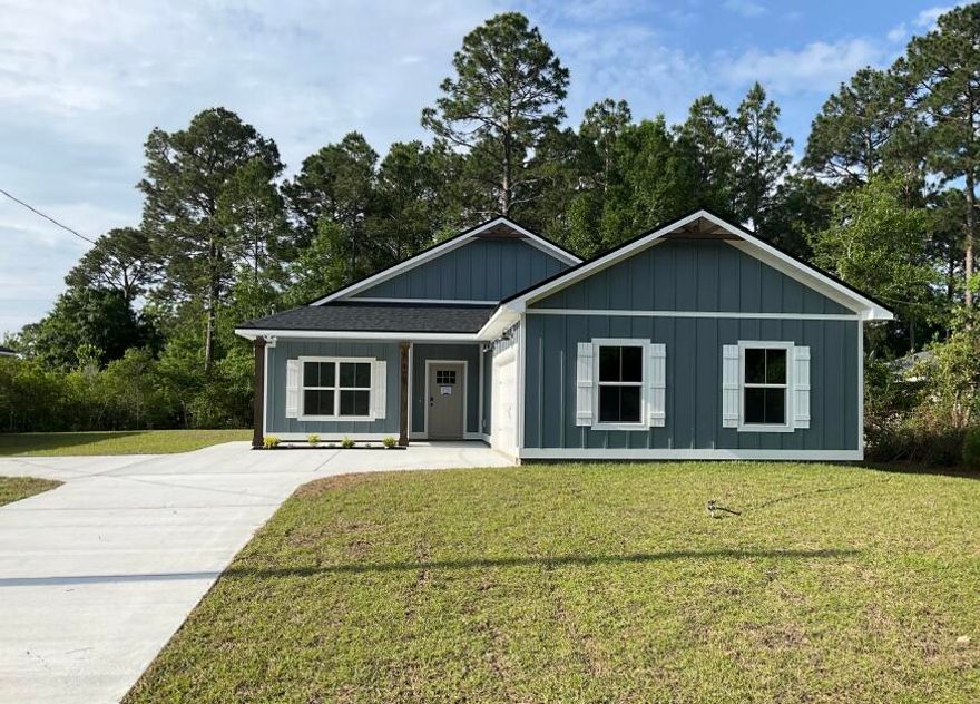 Newly completed and ready for move-in! NO HOA, 5 minutes to Navarre Beach! This semi-custom home offers 1965 square feet of spacious living with 4 bedrooms, 2.5 bathrooms, and an expansive backyard! The home's standout features include custom cypress wood beams and vaulted ceilings, adding warmth and character to the already beautiful design. The walk in pantry, gas range, and side-entry garage make for a modern and comfortable living experience that you'll enjoy every day. Don't forget your gas fireplace to cozy up to on those chilly overcast days! The master bathroom boasts a luxurious free-standing tub and beautifully tiled shower, offering a spa-like experience at home. You'll never have to worry about running out of hot water with the tankless water heater - a feature that will  surely impress. This is not your average builder-grade house - it's a true gem with curated designer fixtures and finishes. With a focus on personalized service and attention to detail, you can trust that your home-buying experience will be second to none. Contact us today to learn more about how you can make this house your forever home!