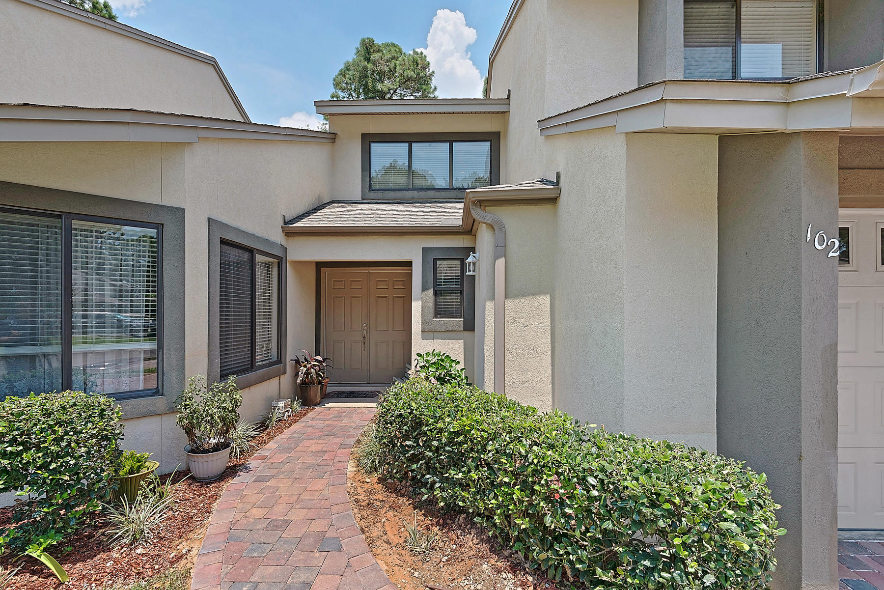 Highly desirable town home in Bluewater Bay at Gleneagles boasts over 2,200 square feet of open, living space. Built in 2005, this three bedroom, two and a half bathroom beauty is full of designer touches. The first floor features a bright and airy open floor plan with vaulted ceilings and lots of windows to let in plenty of natural light. The central living room includes custom cabinetry and a cozy fireplace. Grab a seat at the breakfast bar to enjoy the spacious kitchen. Chefs will love the solid surface countertops and stainless steel appliances. The nearby dining area provides additional space for entertaining with even more natural light. The master bedroom, located on the first floor, also features high ceilings and a giant master bathroom. Two additional bedrooms are located upstair