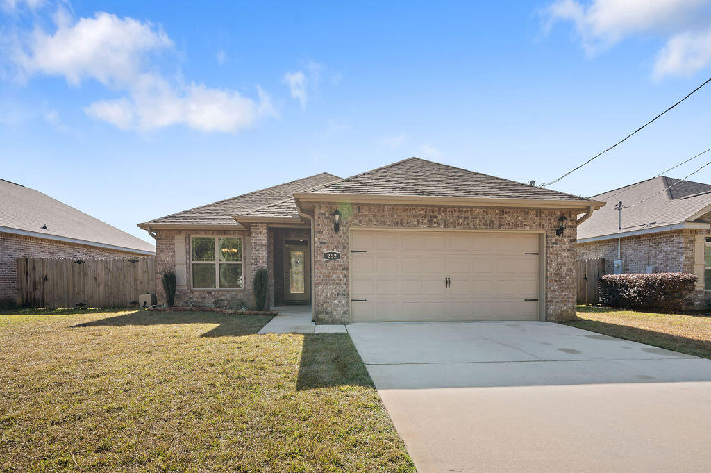 252 Schneider Drive is a beautifully crafted 2019 home that combines quality construction and modern comfort. This 5-star energy-compliant home is designed to optimize energy efficiency and minimize utility costs. Located in the heart of the Florida Panhandle, it offers exceptional convenience, just minutes from the area's renowned white sandy beaches, local Air Force bases, a top-tier hospital, excellent schools, and a variety of shopping and dining options. One of the home's standout features is its paid-off solar panels, keeping the average electricity bill to an impressively low $40 per month. Step inside to find a well-thought-out, family-friendly layout. The split floor plan and open-concept kitchen and living space cater to both daily living and entertaining. The kitchen is equipped with soft-close maple cabinets, granite countertops, and a breakfast bar that offers both functionality and style. The main living areas, bathrooms, and laundry room feature wood-look tile flooring that is both durable and attractive. High ceilings throughout the home enhance the sense of space, creating an open and inviting atmosphere. The master suite provides a comfortable retreat with a tray ceiling, a spacious walk-in closet, and an en-suite bathroom complete with a garden tub, separate shower, and double vanities. Every detail of this home has been carefully designed to balance form and function. Whether you're hosting guests or unwinding, this home offers convenience and comfort in a highly desirable location. All information is believed accurate but should be independently verified by the buyer.