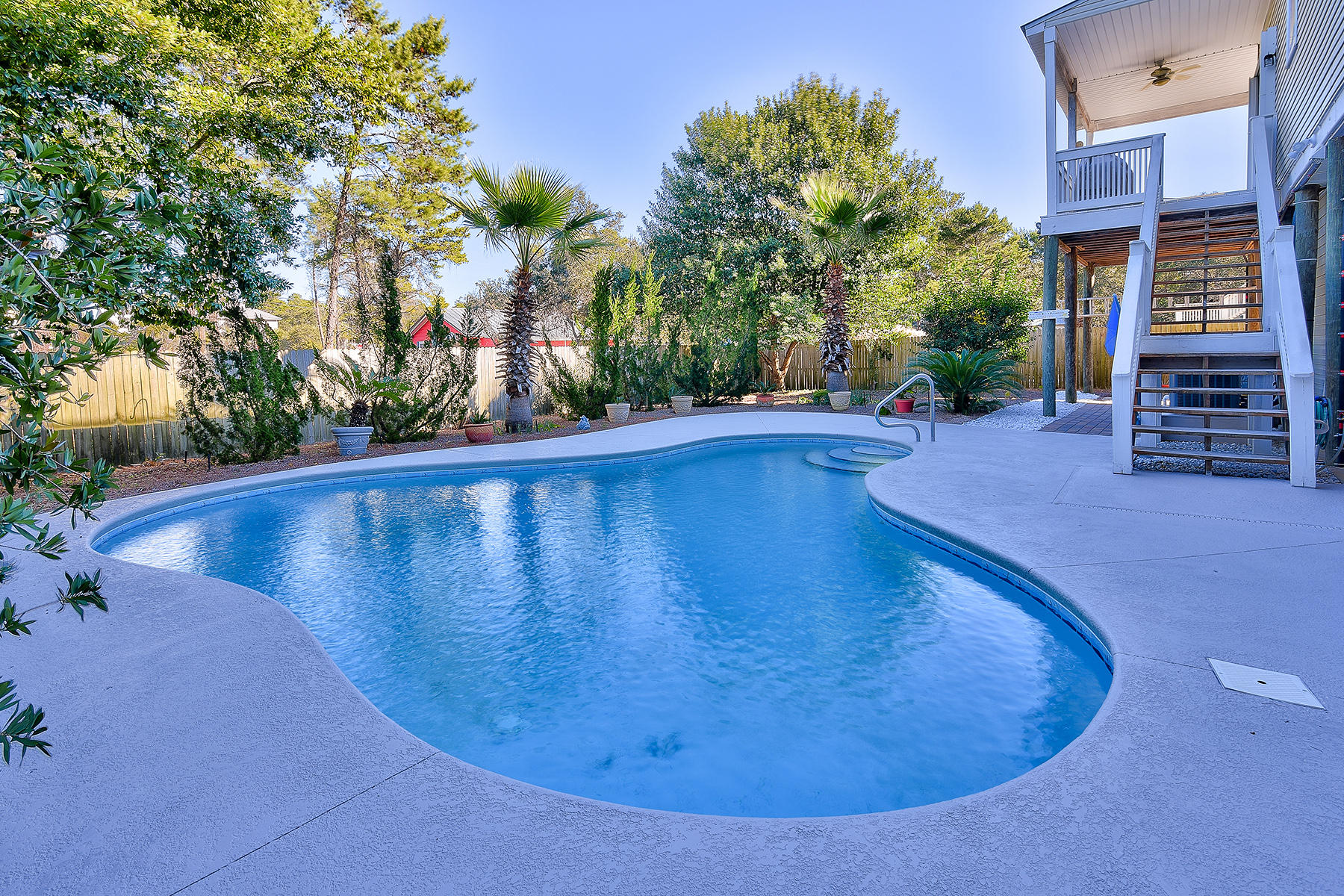 Motivated Seller! South of Scenic Hwy 30A and within 400 yards of beach access with rest facilities and lifeguard tower. This fastidiously maintained GulfView Heights beach home has 2 open living areas, a spacious master bedroom, and one of two guest bedrooms organized on one floor. An additional 2nd floor living area is enjoyed by the upstairs guest bedroom. Mature landscaping maintained by an irrigation system joins other low-maintenance features that include roll-down storm shutters and newer metal roof. The completely fenced yard includes a generous gunite saltwater swimming pool. Tackle hobbies year-round in the heated and cooled workshop and clean-up after the beach in the outdoor shower. Parking for four vehicles means there is always room for guests