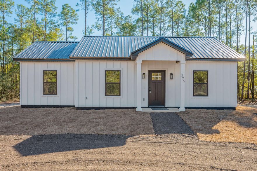 This new construction home is serving up charm on over a half-acre lot. Construction is complete and it's move-in ready! Nestled on a county-maintained road means easy access right to your driveway. The curb appeal is on point with fresh sod landscaping, a covered front entry, and a concrete pad, covered back patio. Need parking? No problem. The gravel pad has you covered with plenty of parking space. Wrapped in classic board & batten, Hardie Board siding and topped with a sleek black metal roof, this beauty was built to last. Step inside to an open living space. The living & kitchen areas have vaulted ceilings with the bedrooms and bathrooms all featuring 9' ceilings. If an airy & spacious feel is what you are looking for, this one meets that goal! Luxury vinyl plank flooring runs throughout with shaker-style cabinets, granite countertops, and stainless-steel appliances. The split floor plan has the master suite off to one side of the home with a double sink vanity & shower-tub combo, while on the other side of the home, sits two more cozy bedrooms cradling another full bathroom. Ceiling fans are placed in every room bedroom and the living area with some recessed lighting throughout. With the spacious property being over half an acre, there's plenty of room to explore options for desired outbuildings. This home was built beautifully and is a must see! Contact your favorite realtor to schedule a tour!