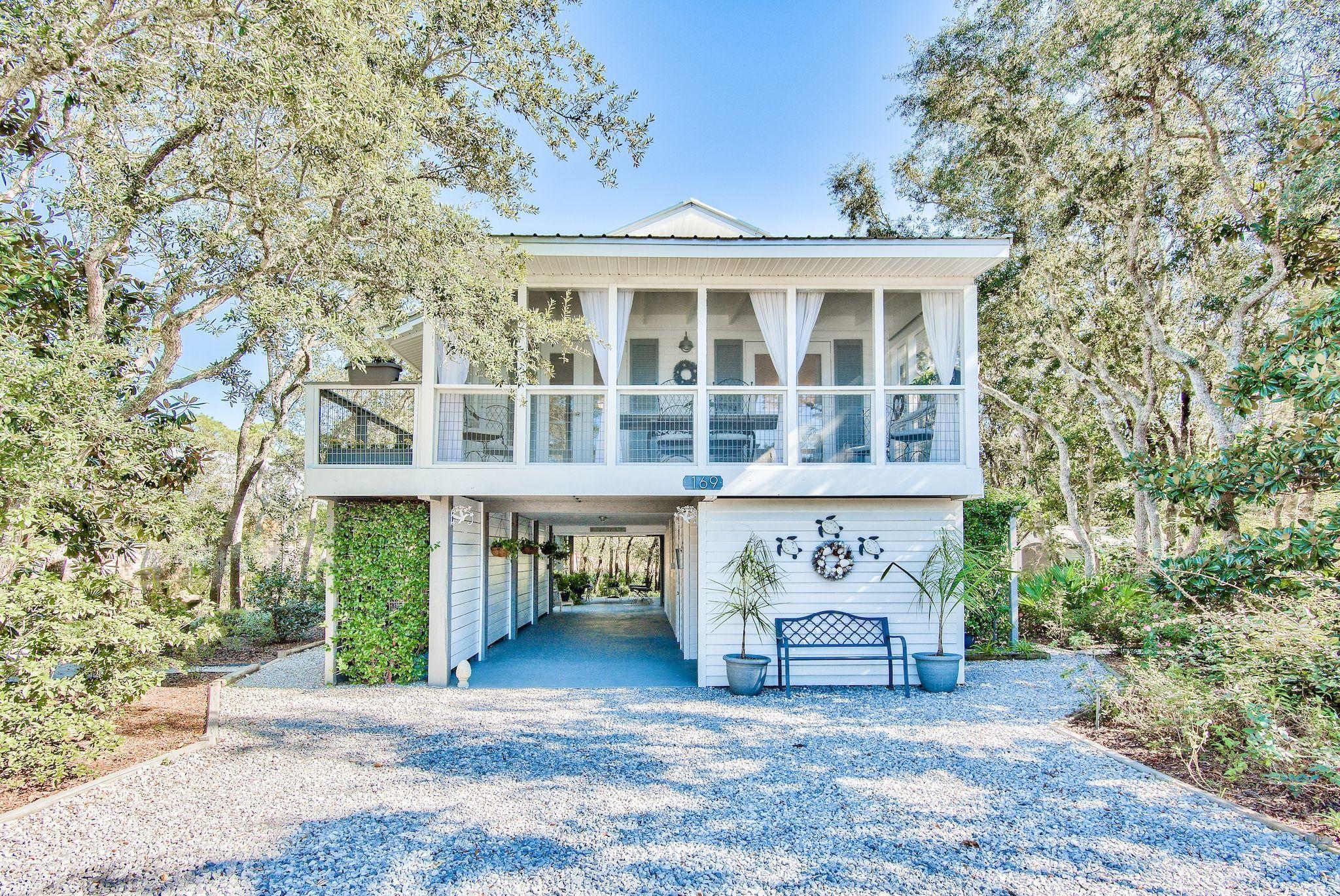 In the heart of Seagrove, on an iconic coastal lake, you will find an adorable cottage nestled on an extra-large, lakefront lot with an abundance of natural vegetation. The cottage is completely remodeled with three bedrooms, two bathrooms, and generous outdoor living space. The 0.337-acre lot has 110' on the road and 75' on the lake.  Meander through the sandy trails, meticulously created among Live Oaks, Water Oaks, Scrub Oaks, Magnolia trees, Youpons, Saw Palmettos, and other original vegetation. The owners planted Pittosporium, Azaleas, Gardenias, Lariope, and various wildflowers and flowering plants throughout the property, complementing the old growth on the lot.