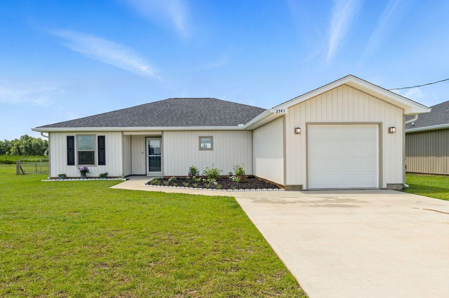 Tucked away in the peaceful countryside, this beautifully maintained 2022-built home offers the perfect blend of modern comfort and quiet rural living. Set on 1.5 acres, with the backyard fully fenced, this property provides ample room to relax, entertain, or store your RV or boat with ease thanks to gated side access and no HOA restrictions. Step inside to find luxury vinyl plank flooring and fresh neutral paint throughout, creating a warm and inviting atmosphere. The open-concept floor plan connects the living room and kitchen, with vaulted ceilings and abundant natural light enhancing the airy, open feel. The kitchen is a showstopper with white soft-close cabinetry, stainless steel appliances, a large island, shiplap accent wall, and granite countertops. The split-bedroom layout offer s privacy, with the primary suite tucked away for quiet retreat. The en suite bathroom features a large shower, a vanity with a granite counter top, and a generous walk-in closet. Two additional bedrooms, each showcasing scenic countryside views, are located on the opposite side of the home and share a full bathroom.. Additional highlights include a one-car garage, and a dedicated laundry room. The backyard perfectly encases country living! It features a deep, fully fenced-in area ideal for chickens, horses, or dogs, with plenty of room to roam and play. Whether you're hosting gatherings, starting a small hobby farm, or simply enjoying the peace and quiet of the outdoors, this space offers endless possibilities. With no HOA and extra acreage extending behind the home, you'll have the freedom and space to truly make it your owncountry living at its finest with all the modern comforts.