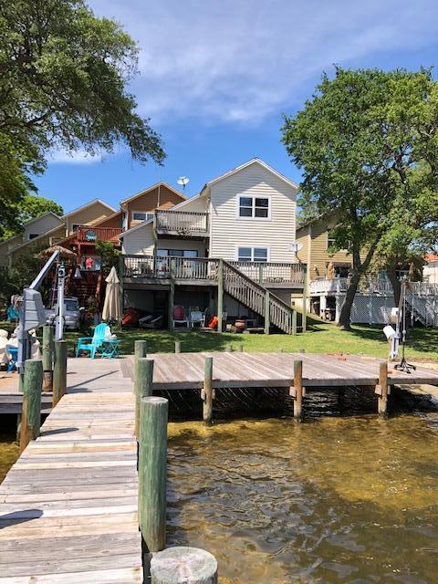 Enjoy the fireworks and sunsets from your beautiful dock! 29 feet of intercoastal waterfront including walk-in beach access, dock, boat lift, and jet ski lift. built up so first level in back is used for storage/work shop. Decks galore with views of the water from dining/living rooms and both bedrooms upstairs. Fireplace. One car garage with long driveway for ample parking. Interior washer/dryer hookups. Interior needs work/updating.