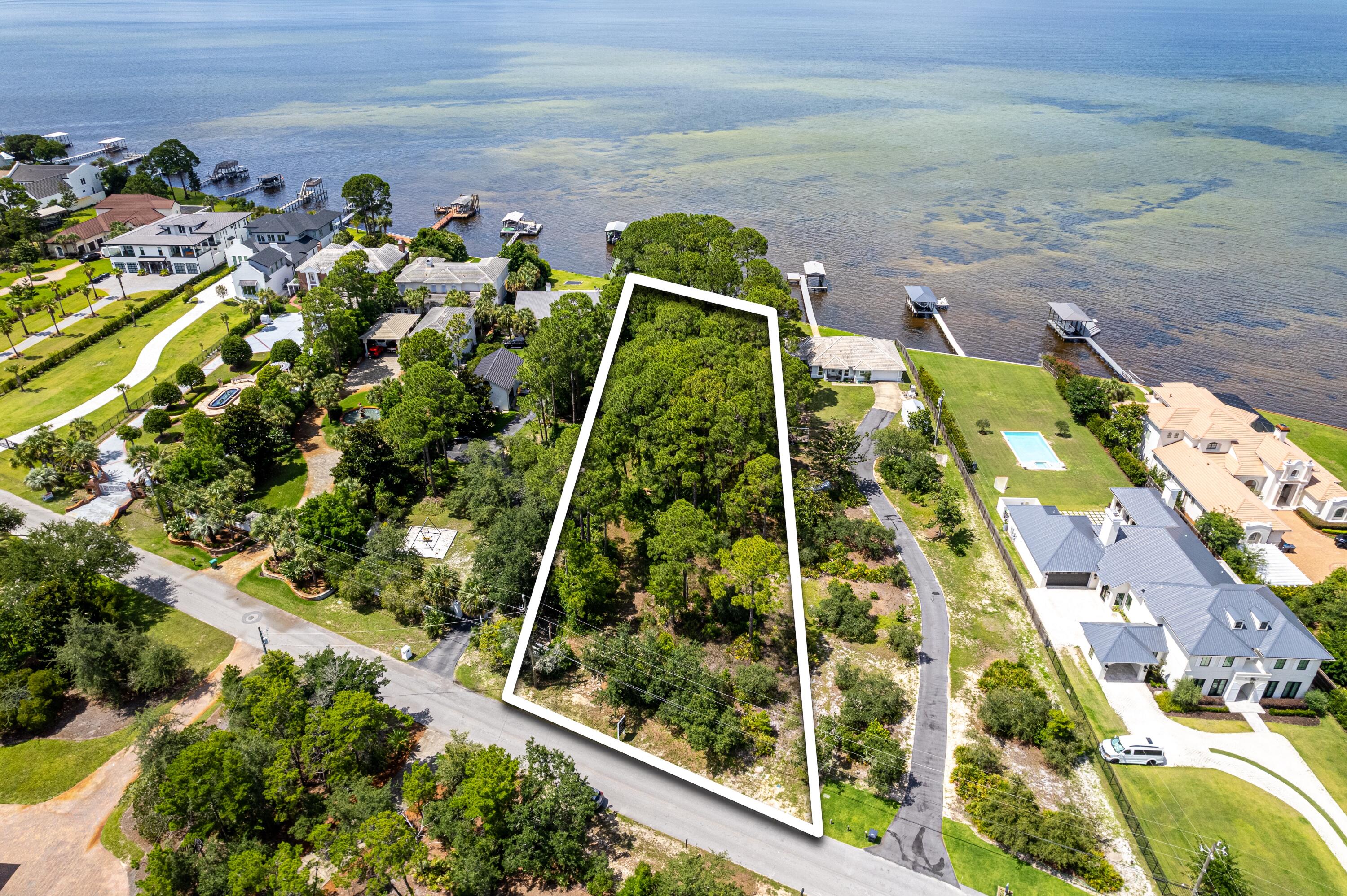 Very rare, deep, wooded lot with 100' of bay frontage on quiet Walton Way. Your opportunity to own one of very few bay front, estate-sized lots remaining and no HOA!