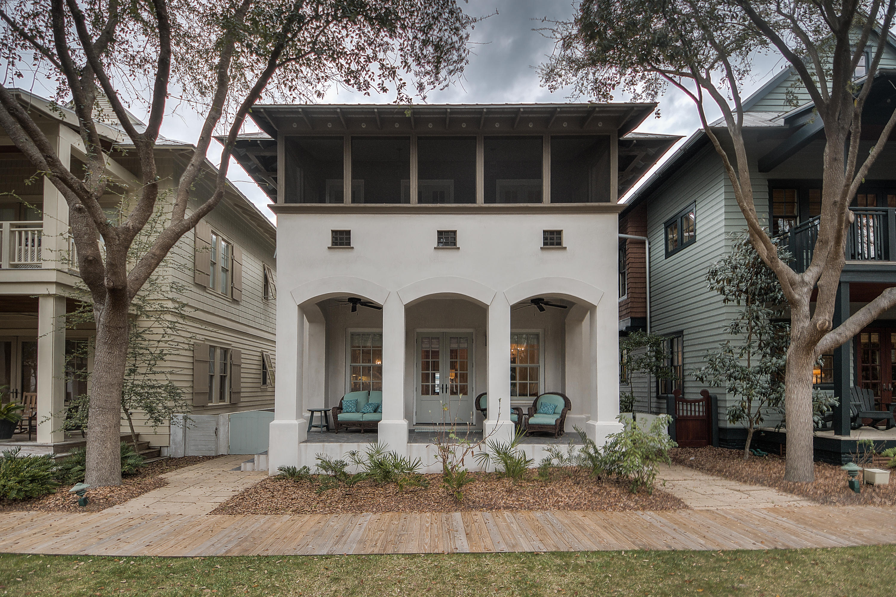 Tucked neatly along one of Rosemary Beach's coveted pocket courtyards is where you find this charming beach cottage that has been completely renovated and newly furnished. Graced by double front porches perfect for enjoying the park-side tranquility, this three plus bedroom home will neatly satisfy the longings of your family for a home in Rosemary. As you enter, you sense a bit of old New Orleans ''shotgun style'' in the way the house is open from front to back. Wire brushed oak flooring runs seamlessly throughout and tall ceilings heighten your senses. There are exterior shutters on the first floor side windows to let light in yet allow for privacy. The main living, dining and kitchen flow gracefully together to enhance the openness and allow the chef to take in the beautiful courtyard
