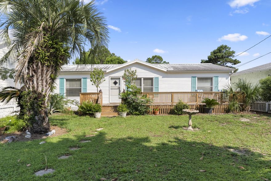 Step into a fully renovated mobile home, with LVP flooring, new bathroom vanities, a newly built large front deck, a new 8 ft fence surrounding a large backyard and back deck with a fire pit and outdoor shower, making the back yard perfect for entertaining. Two sliding glass doors that exit the home into the back yard perfect for grilling and nights by the fire. 3 minute walk to the public beach access, or 5 minutes to all the main dining and entertaining in Panama City Beach and 10 minutes to Pier Park. Elevated ceilings that make the home feel large , bright and spacious. Wood beams throughout the living room and dining area. Three great big bedrooms all with  big windows and plenty of natural light that gets in . A storage shed in the backyard for lawn tools or extra storage.