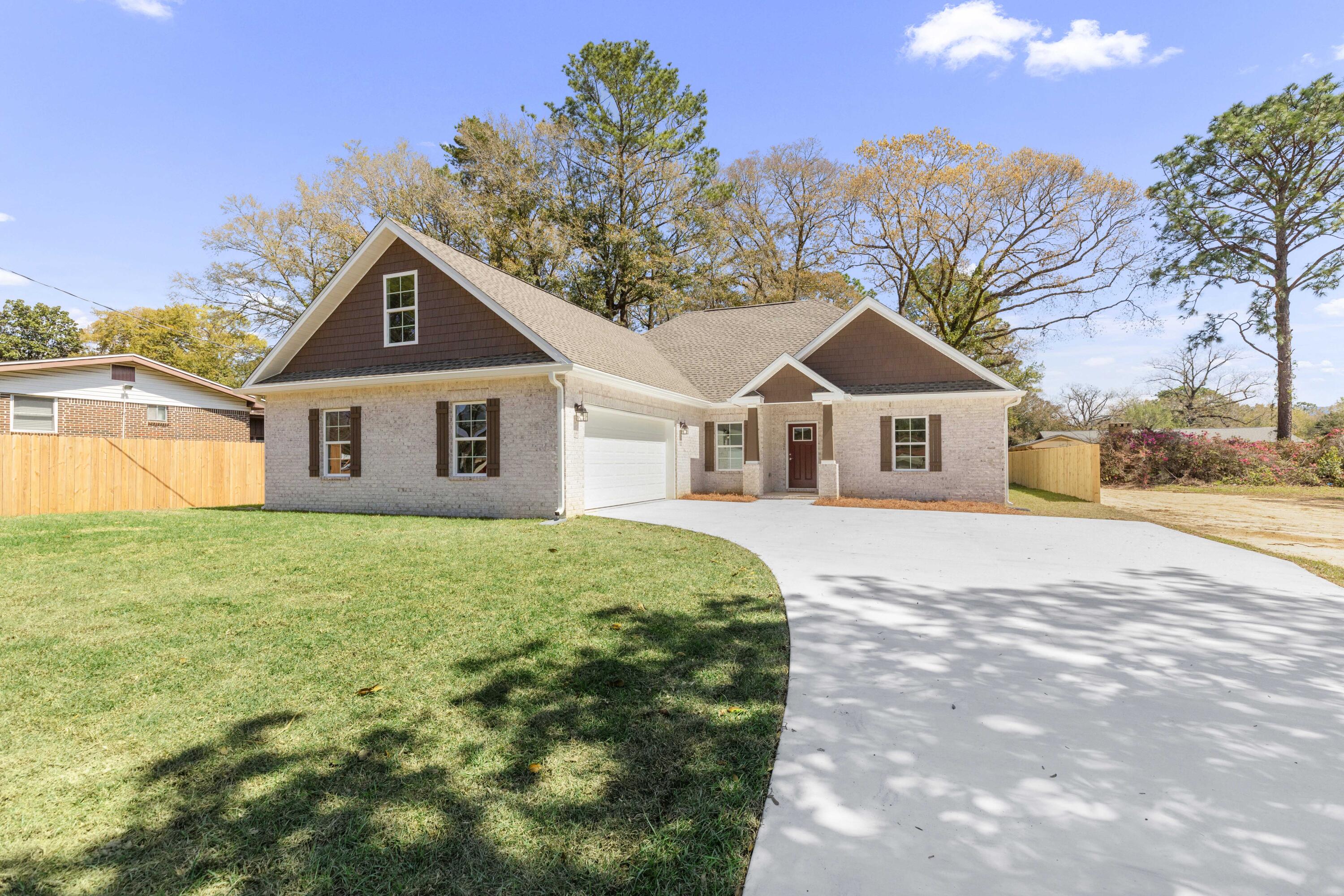 NEW CONSTRUCTION HOME!!! - MOVE-IN READY FOR NEW HOMEOWNERS! Beautiful white brick 4 bedroom 2 bathroom two story home with side entry garage on a 0.26 acre lot. This home offers LVP wood flooring throughout (no carpet!), matte granite throughout, SS appliances (refrigerator, oven, microwave, dishwasher), separate tub and shower with glass enclosure in master bathroom with tile surround, tray ceilings in both the master bedroom and the living room with crown molding. This home is an open concept split floorplan that buyers have come to expect. This home offers a large living room with tray ceiling, formal dining room, and separate dining area. Two additional bedrooms are on the first floor as well as a full bathroom, with the 4th bedroom on the second floor, all with ceiling fans. The home also offers a two car side entry 26x24 oversized garage and a covered back porch that can easily be screened in. The exterior of the home has an extended backup pad, gutters, faux wood shutters and privacy fence separating you from your neighbors. This home is centrally located in the beautiful Adams Powell Subdivision, convenient to schools, shopping, beaches, and bases. Did I mention NO HOA? Do let this brand new beauty slip away. Schedule your showing today!