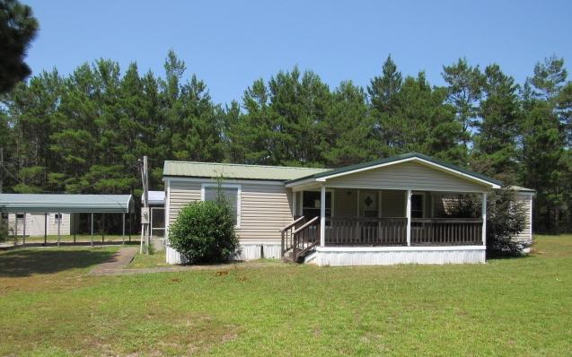 Price reduced on this 2.48 Acres in Walton County with 3 Bedroom 2 bath mobile home REO opportunity. This property has a single car garage and two car ports and a shed. The larger carport can accommodate an RV. The property is very private off Rainbow Drive. The front of the mobile home has a large covered patio with enough room to entertain. The back of the house is covered leading to the garage and has been closed in. The home has a split bedroom floor plan. To include two living areas one with fireplace. The kitchen has a breakfast bar and a dining area. There is also a good size laundry room. Buyer to verify all pertinent information as to satisfy themselves. Property being sold 'as is'.