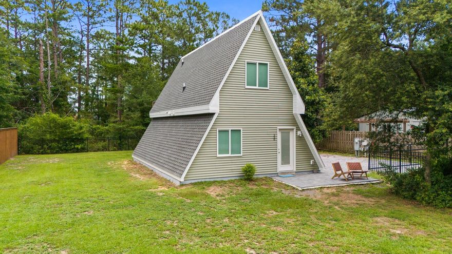 This thoughtfully finished A-frame home offers a rare opportunity to own a truly unique property near Choctawhatchee Bay. Situated on a spacious lot with no HOA, this 927 square foot home delivers charm, modern comfort, and outdoor functionality -- all just minutes from water access.The main level features an open concept with living and dining areas, and a sleek modern kitchen with shaker cabinetry, quartz countertops, stainless steel appliances, and a custom stone backsplash over the range. Also on the main level is a full bathroom with a freestanding tub with shower and a laundry area. The second story features a spacious bedroom suite with double vanity, and a separate walk-in shower with glass door and rainfall fixture. The layout maximizes functionality and comfort in every space.
Outdoors, the property is equipped with full RV hookups - sewer, water, and 30amp electric, a 12x16 outbuilding with wood-accented barn doors, and a private outdoor shower - ideal for rinsing off after a day on the water. The expansive fenced yard provides ample room for boat parking, trailer storage, outdoor entertaining, or even future expansion.
Located just a short drive from Grady Brown Park, where residents and guests enjoy boat ramps, fishing piers, a kayak launch, picnic areas, and a playground  making this a perfect hub for outdoor living. The white sand beaches of South Walton and 30A are just 15 miles away. Whether you're looking for a peaceful primary residence, low-maintenance retreat, or a vacation rental investment, this property offers flexibility and appeal in a growing area.
