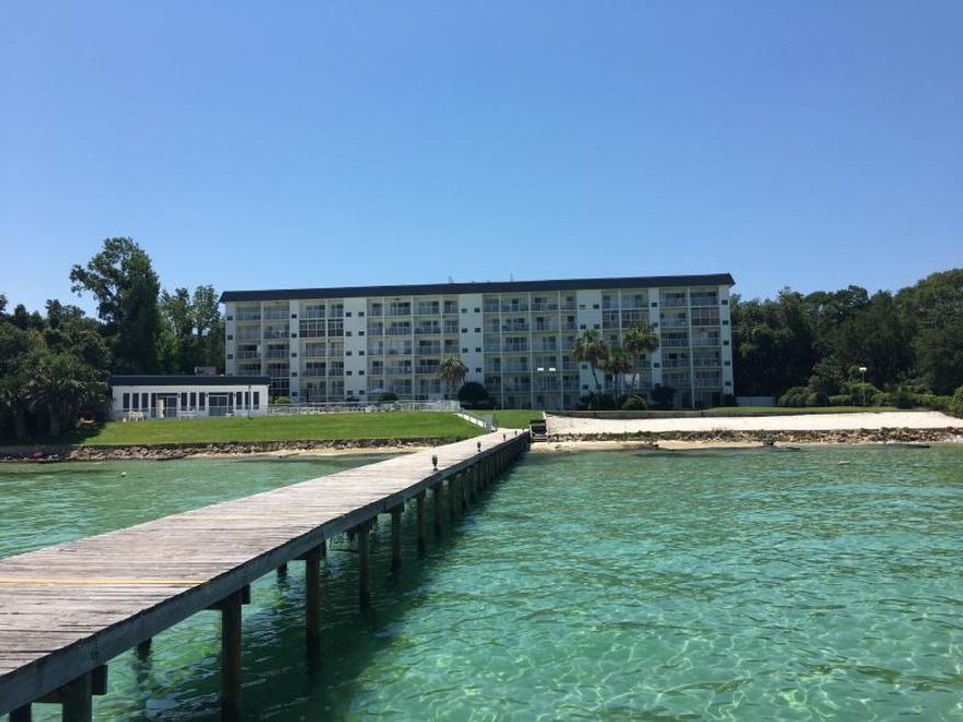 Waterfront and affordable! Enjoy great views of Choctawhatchee Bay and Crab Island from the living room and balcony. Small condo community features direct water access via private dock to Destin's famous Crab Island on Choctawhatchee Bay at the foot of East Pass and Destin Harbor. 2nd story condo with tongue-and-groove, real oak hardwood flooring in living room with a comfortable layout that flows well.  Private balcony overlooking, community Bay-front pool, with club house and tennis courts just minutes from beaches, restaurants, shopping and entertainment. Dock, benches, fish cleaning station and private sandy beach. On-site storage for kayaks and paddle boards. Easy living with on site maintenance staff. Would make a perfect low maintenance home.