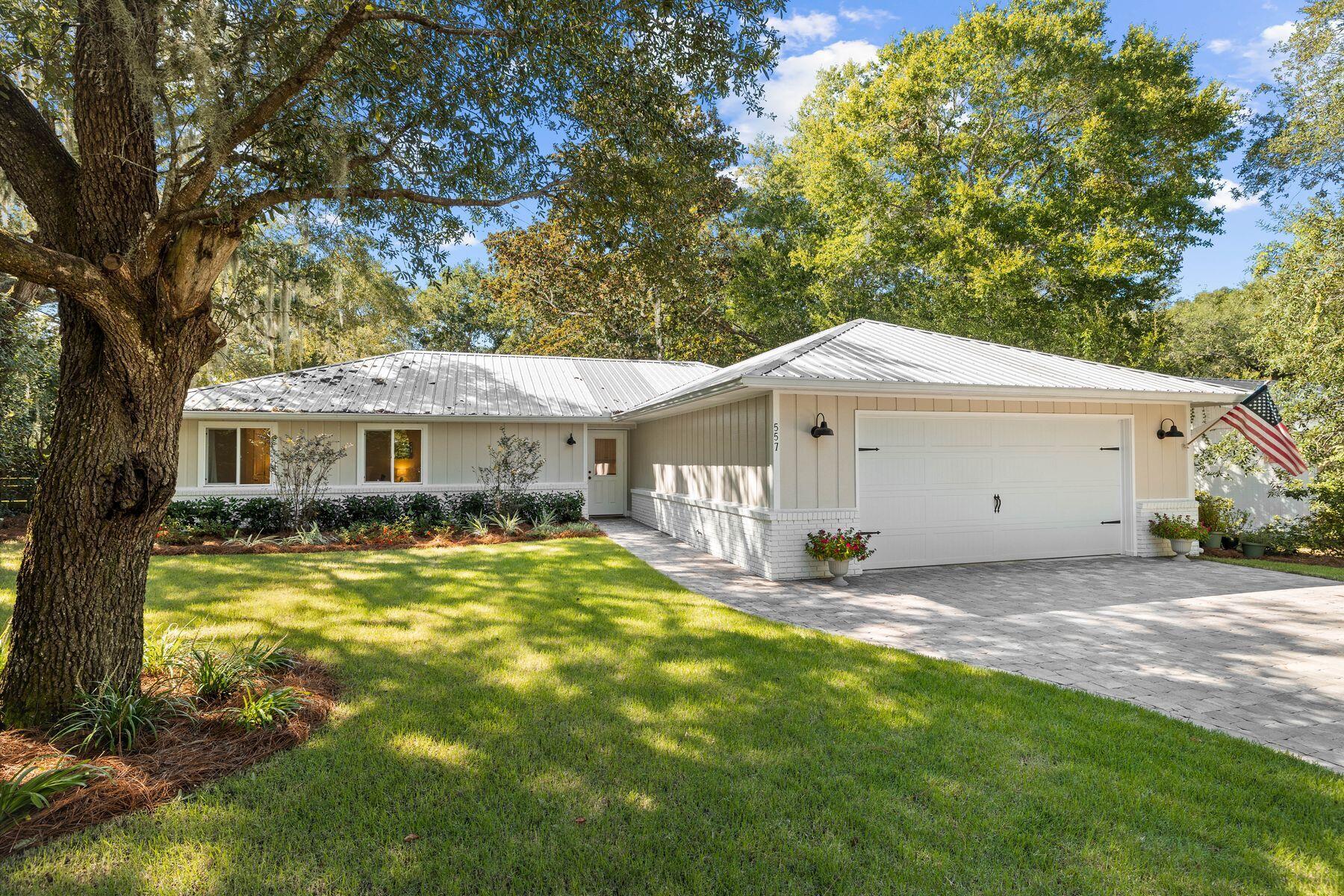 This exceptional renovated ranch home in Point Washington presides over a quarter-acre lot filled with mature oaks and magnificent magnolias. It's in a sought-after location close to Choctawhatchee Bay, beautiful sandy beaches and state forest trails. Recent renovations took this single-story home back to the studs and rebuilt everything from the LVP wood flooring to a new roof and gutters. Fresh paint inside and out, new lighting, new bathrooms and a gourmet kitchen. The entire siding on the back of the house was removed and three sets of French doors now connect the bright and spacious living room with the screened porch and covered barbecue area. Once the home was transformed, the owners turned their attention to the landscaping, creating a lush private wonderland for laid-back outdoor living with new lighting and outdoor spotlights. A new irrigation well pump keeps everything well-watered, even when owners are absent. The open kitchen had a complete makeover, which included relocating the HVAC to provide a pantry. As well as new cabinets, stainless steel appliances and quartz countertops, updates include a new kitchen vent fan. The laundry room has updated shelving and a useful butcher's block counter. This beautiful home has three large bedrooms and two bathrooms. California Closets provide covetous storage in the bedrooms and the newly expanded master bathroom boasts beautiful tile flooring, a twin vanity, new mirrors and more. The newly pavered driveway was widened to provide ample parking for four vehicles in front of the two-car garage. A nicely paved walkway leads to the fenced backyard and firepit patio. With no HOA, this fully renovated home enjoys an enviable location close to boat access, Grayton Beach and 30A shops and restaurants. It delivers the sort of lifestyle that dreams are made of. 