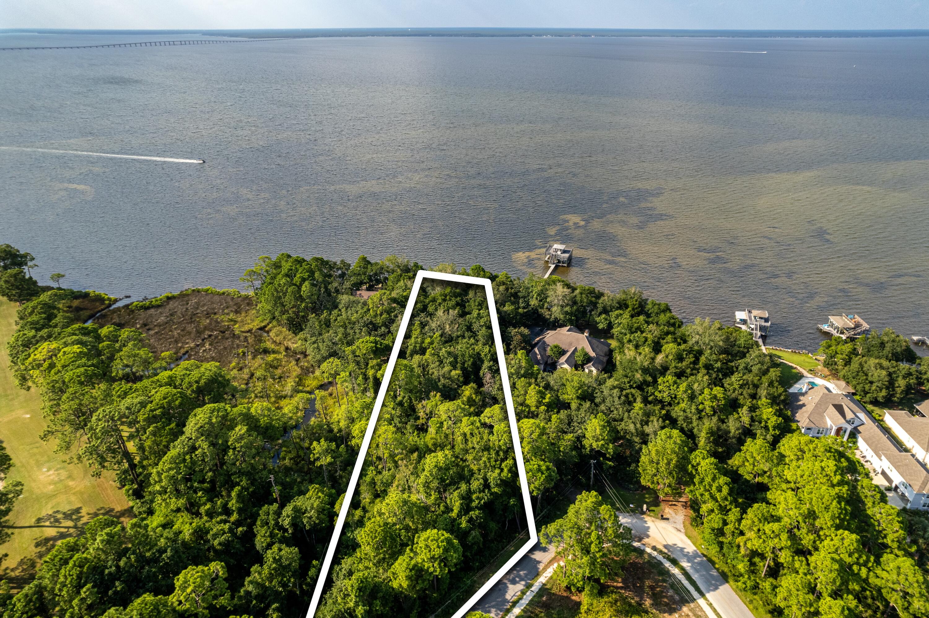 100 FEET OF  SHORELINE ON THE BAY. Enjoy pristine views,  excellent location and NO HOA fees or restrictions! Over an acre of property to design and build your waterfront playground with dream home! Location of where a future home could sit is ZONED X, a bonus for Home Insurance Rates.