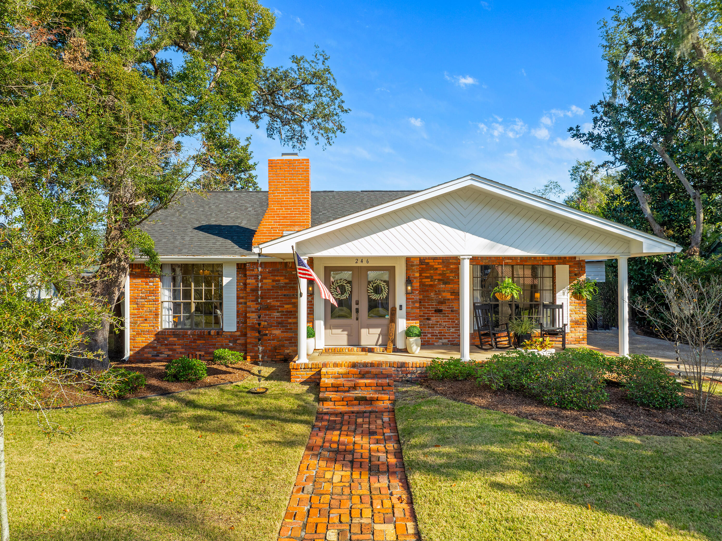 This beautifully renovated ranch-style home in the historic Bunkers Cove neighborhood offers a lifestyle of comfort, convenience, and charm.Under a new roof, this brick-built single-story cottage harmonizes timeless appeal with modern convenience. A brick-paved path welcomes you to the front porch and through double front doors into a home filled with character. Original hardwood floors and a gas brick fireplace set the tone in the cozy living room, dining area, and bedrooms.The oversized chef's kitchen is a showstopper, featuring new LG appliances, a stunning brick accent wall, and a honeycomb tile backsplash. Each bedroom offers custom closets for ample, organized storage, while fresh paint throughout the interior and exterior enhances the home's appeal. The nearly quarter-acre lot is fully fenced for privacy, creating a safe haven for pets and children. Outdoor living shines with a spacious covered living area, a paver patio, and lush new sod complemented by an updated irrigation system.

Parking and storage are effortless, featuring driveways at both the front and rear with ample space for boat or RV parking, along with a pull-through oversize carport.

Situated in a golf-cart-friendly community established in 1907, this home is conveniently close to Tyndall Air Force Base and downtown Panama City. Boaters will appreciate the proximity to St. Andrew's Yacht Club and the serene waters of St. Andrew Bay.