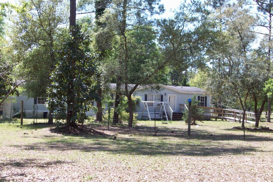 Are you looking for a home with room for your animals? Here is your opportunity for a 4 bedroom home on 5 acres for your country retreat or as an investment property. This split bedroom plan has a Master bedroom with French doors leading to a sitting area, a great room with a corner fireplace and a covered back porch. This fenced and crossed fence property has 2 workshops with electric, an attached 20x24 carport for your yard equipment, a shed, and a 4 stall barn, all have dedicated service panels. The barn has 3 12x12 stalls, 1 8x12 stall, and a feed/tack room. You have a 362 ft deep well and water lines throughout the property. The home needs some TLC and a new A/C. Property is being sold 'AS IS'. Buyer to verify SF and room dimensions.