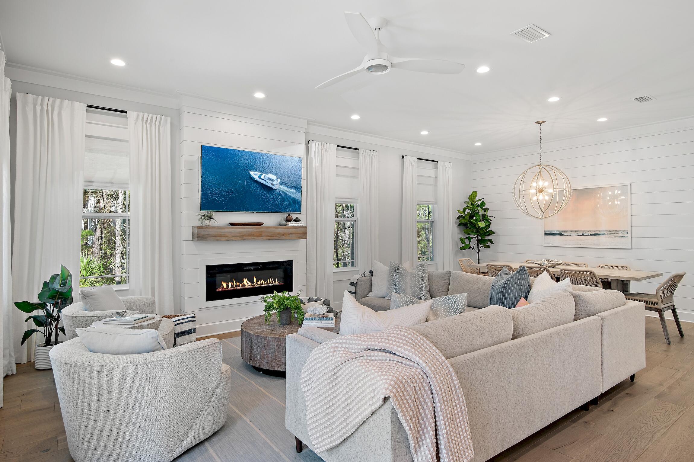 Introducing a remarkable 2021 constructed home, nestled in the highly sought-after Seacrest Beach neighborhood located between Alys and Rosemary Beaches. This three-story home backs up to the nature preserve with outdoor living options on every level, offering serene spaces for reconnecting with friends and family or simply to relax amidst the peaceful surroundings.Experience the stunning details of the custom interior and exterior designer selected finishes, epitomizing refined beach living. Upon entering the home is a charming and open living and dining room where you will find 10ft ceilings, stylish pendant lights, hardwood floors throughout, designer furniture, custom window treatments, and fireplace with a white oak wood mantle. The modern and light filled kitchen has