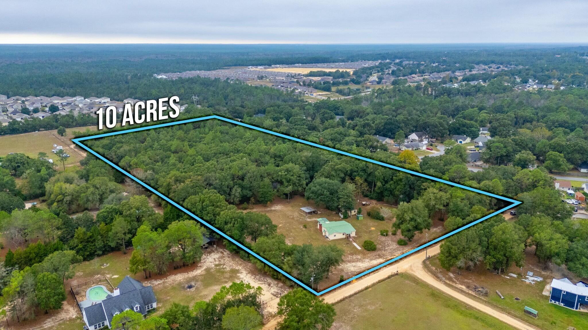 Nestled in the heart of South Crestview, this expansive 10-acre property offers a unique blend of privacy and convenience. A haven for nature lovers, the land is graced with towering oak trees, serene trails, and open, level spaces perfect for your vision. Whether you're seeking a family compound, an investment opportunity, or your private retreat, this property has it all.The main home, a mobile home, and a vintage Airstream camper (built into a structure with two additional rooms) offer a range of possibilities. While all dwellings require a good amount of TLC, their potential is limitlessa"imagine rustic renovations, rental income opportunities, or even building your dream estate amidst the trees.Here, you'll enjoy unparalleled seclusion while remaining just minutes from shopping, schools, and local amenities. Create your oasis, where the mornings are greeted by nature's beauty, and evenings invite endless stargazing under the canopy of majestic oaks.

Opportunities like this are raredon't miss your chance to own a piece of South Crestview's hidden treasure. Schedule your showing today and bring your vision to life!

Main home is 1520 sq. ft 3bed/1bath
Mobile Home is 1071 sq. ft. 3bed/2bath