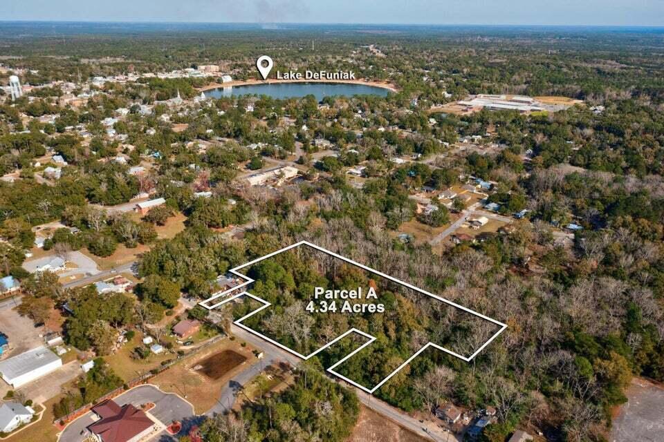 Prime Multi-Use Development Opportunity! Discover 5.03 acres of multi-use zoned land in the heart of DeFuniak Springs, offering flexibility for both residential and commercial development. Ideally located less than one mile from Walmart, Lake DeFuniak, and Interstate 10 (Exit 85), this property is perfectly positioned in a high-traffic, fast-growing area. Whether you're planning retail, office space, multi-family housing, or a mixed-use project, this lot provides endless potential. Utilities nearby with excellent road access. Buyer to verify specific land use and development requirements.