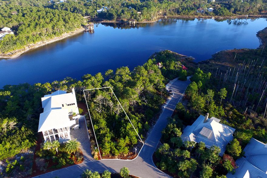 Offering a secluded lakefront location, this exclusive site within the gated, gulf front neighborhood of The Retreat commands a prominent corner location near the westernmost neighborhood beach access. Close by is a canoe launch on Draper Lake, overlooked by a picnic pavilion, play fort, and observation tower. Construction of a dock on Draper Lake from this lot is permitted. Intermittently connected to the Gulf of Mexico, this rare coastal dune lake offers a mix of fresh and brackish water and diverse ecosystem. Additional neighborhood amenities include a gulf front beach club with infinity edge pool and spa, a manned gate house, security patrol, and rental restrictions, preserving the esteem and integrity of this premier location.