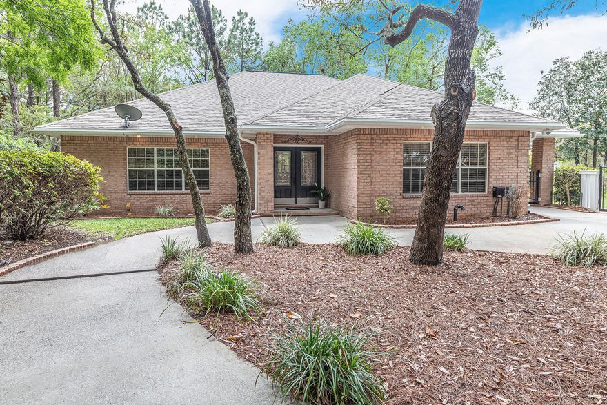 Serenity awaits at this secluded cottage in the heart of Southwind. You will appreciate all the fine details found in this one of a kind home, starting with the beautiful driveway. Open concept living welcomes you. Spacious living room embellished with a gorgeous gas fireplace for added ambiance. The kitchen has an abundance of cabinetry, stainless-steel appliances, large island, and a separate pantry for overflow storage. Two large master suites with separate showers and double vanities. The exterior is secluded, yet offers views of the golf course to remind you that you are in one of the most distinguished parts of Bluewater Bay. Huge back patio, screened in porch and fire pit make this space perfect for entertaining. Ample room for a pool with separate seating areas through out