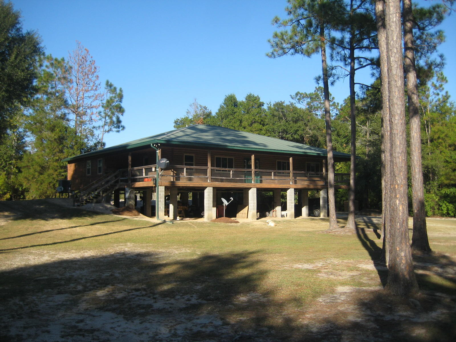 Wonderful custom built home on just shy of 2 acres with picturesque lake views! Great 3 bedroom and 2.5 bath home with a dock on the lake. Enter through the expansive tiled foyer and the view will captivate you immediately. The home features a formal dining room, large office, large living room with a great view of the lake and bathed in natural sunlight - Roomy kitchen and breakfast area are bright and airy also and open to the living room for entertaining. Kitchen features tons of cabinet space and counter tops, tile floors and stainless appliances. Split bedroom design with ample space in the guest bedrooms and a clever Jack and Jill bath between the two. Master bedroom and bath are very spacious and open to the large porch overlooking the lake. Bath features an over-sized tub